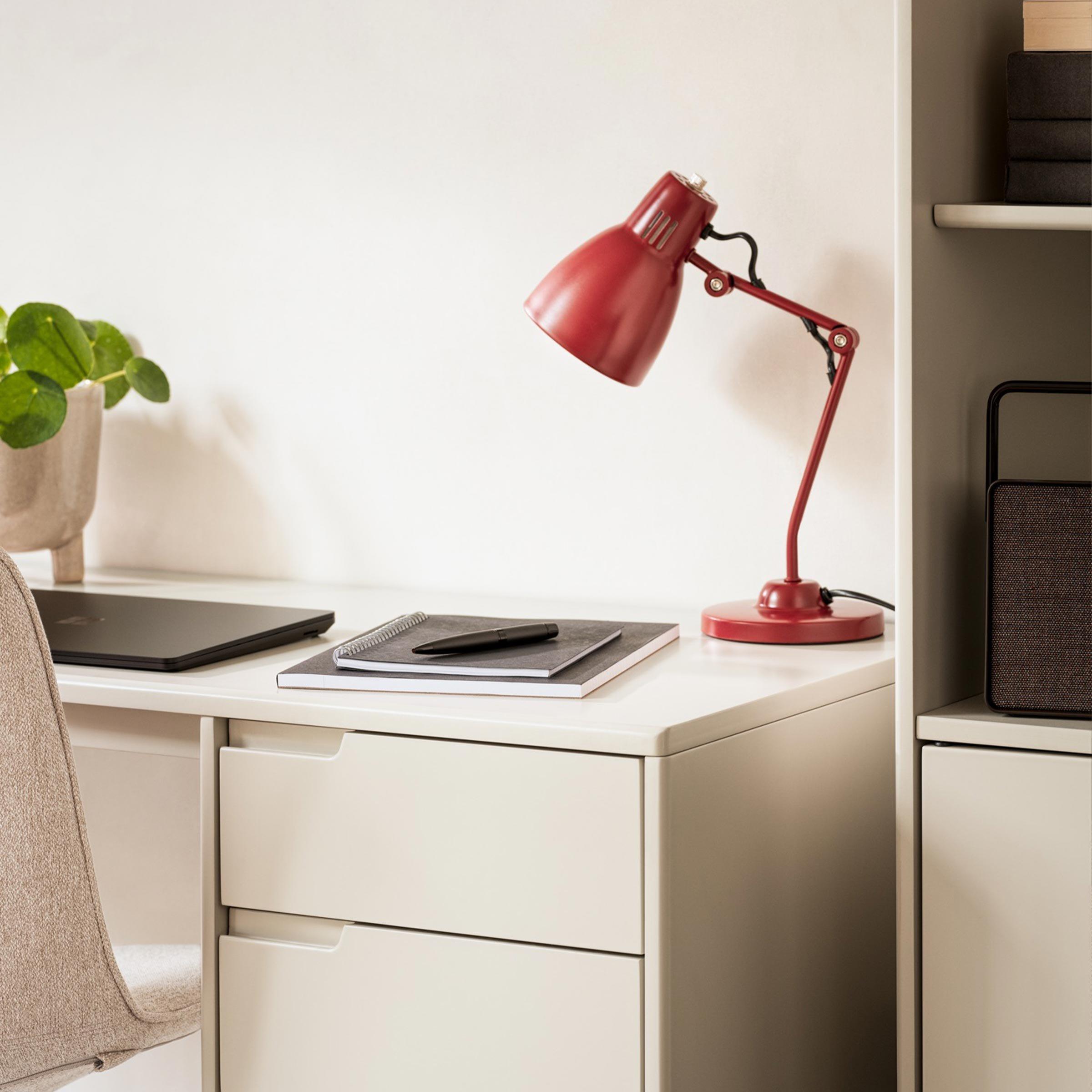 Desk with red lamp on it