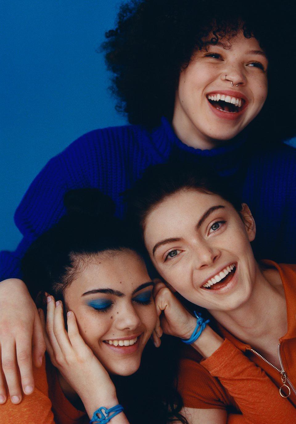 Diverse group of young people on blue background
