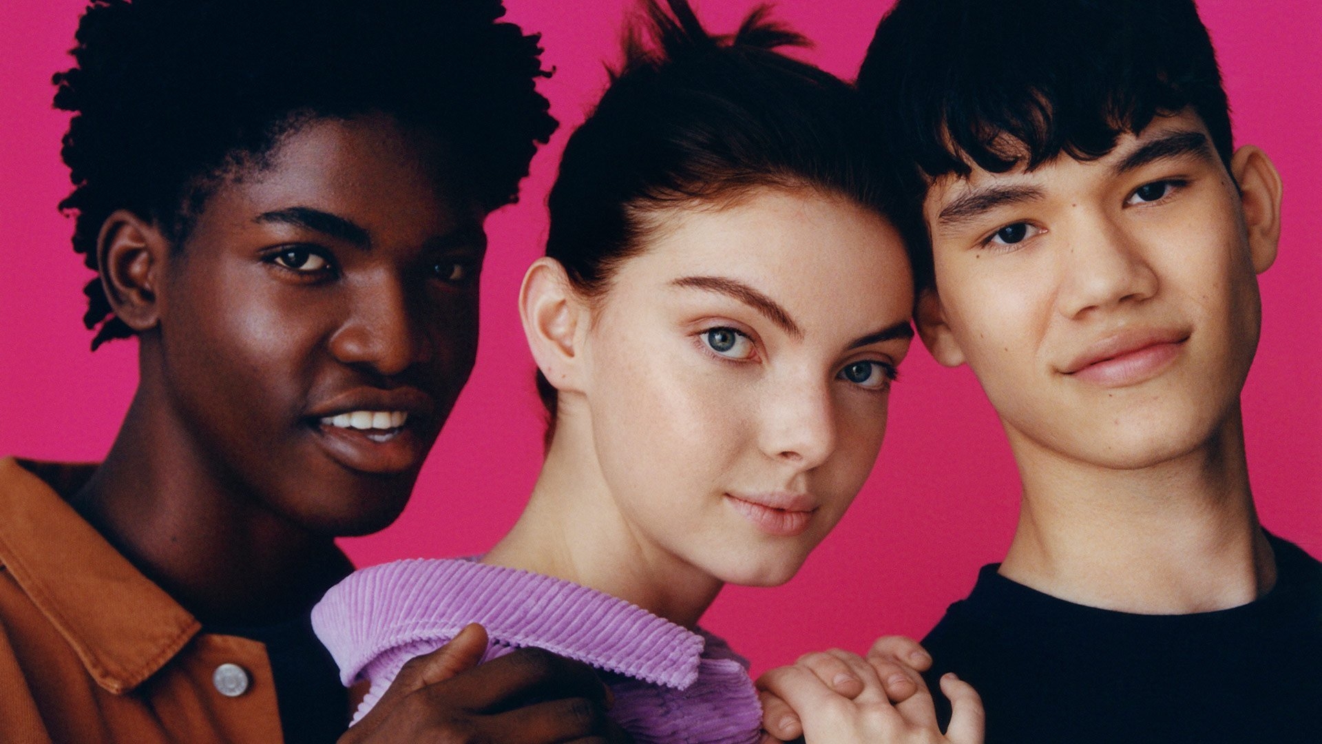 A diverse group of young people on a magenta background