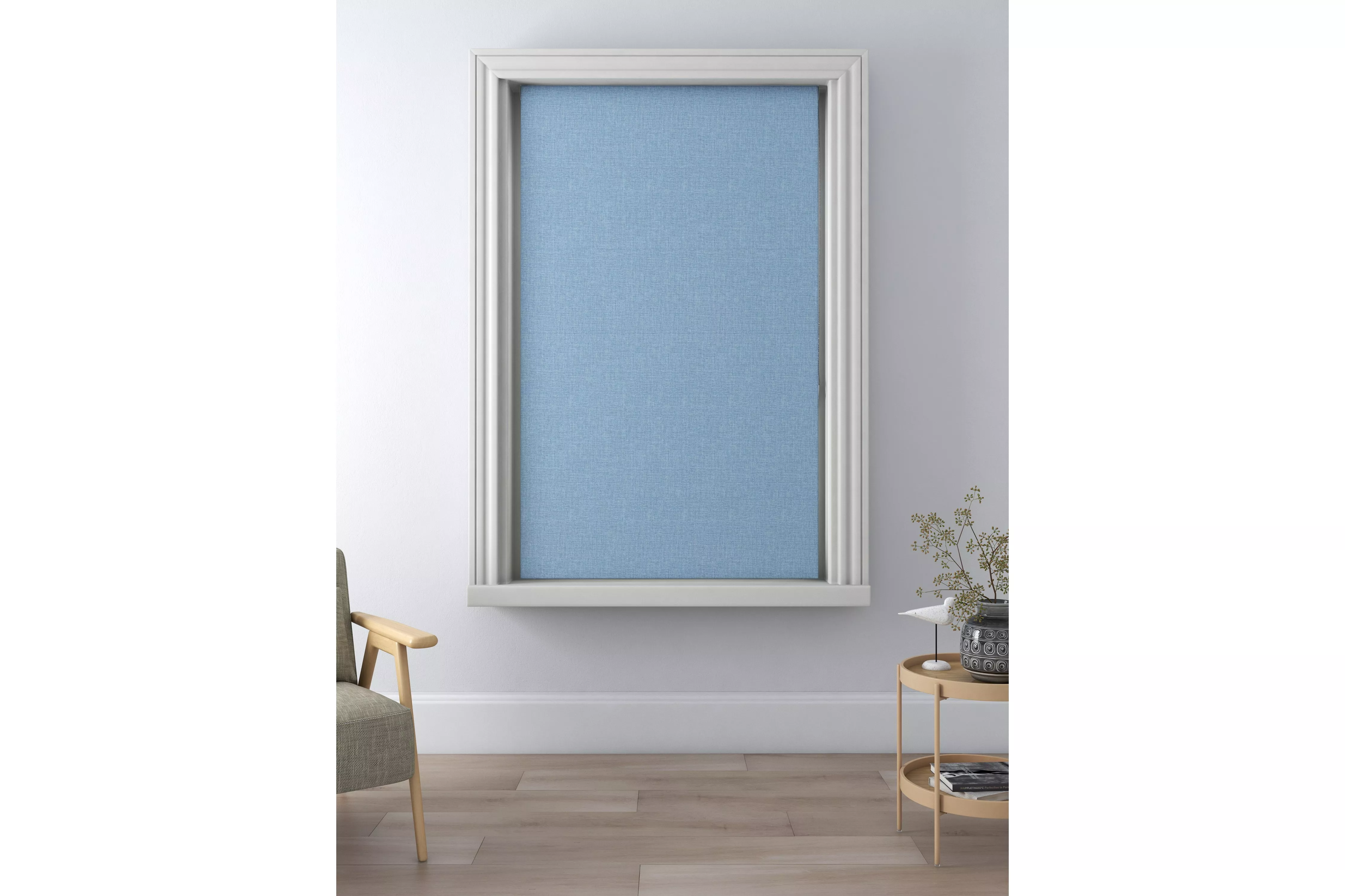 Light blue blackout roller blind fitted in a white recess window frame in a modern living room interior.