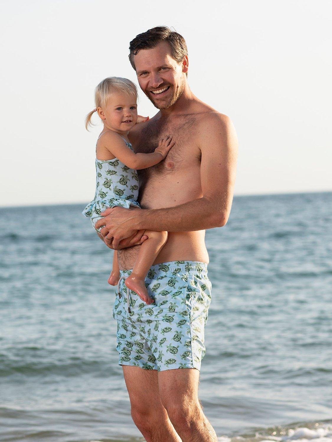 Product image 4 of 6, which shows Trotters Baby Turtle Peplum Swimsuit, Blue, 3-6 months