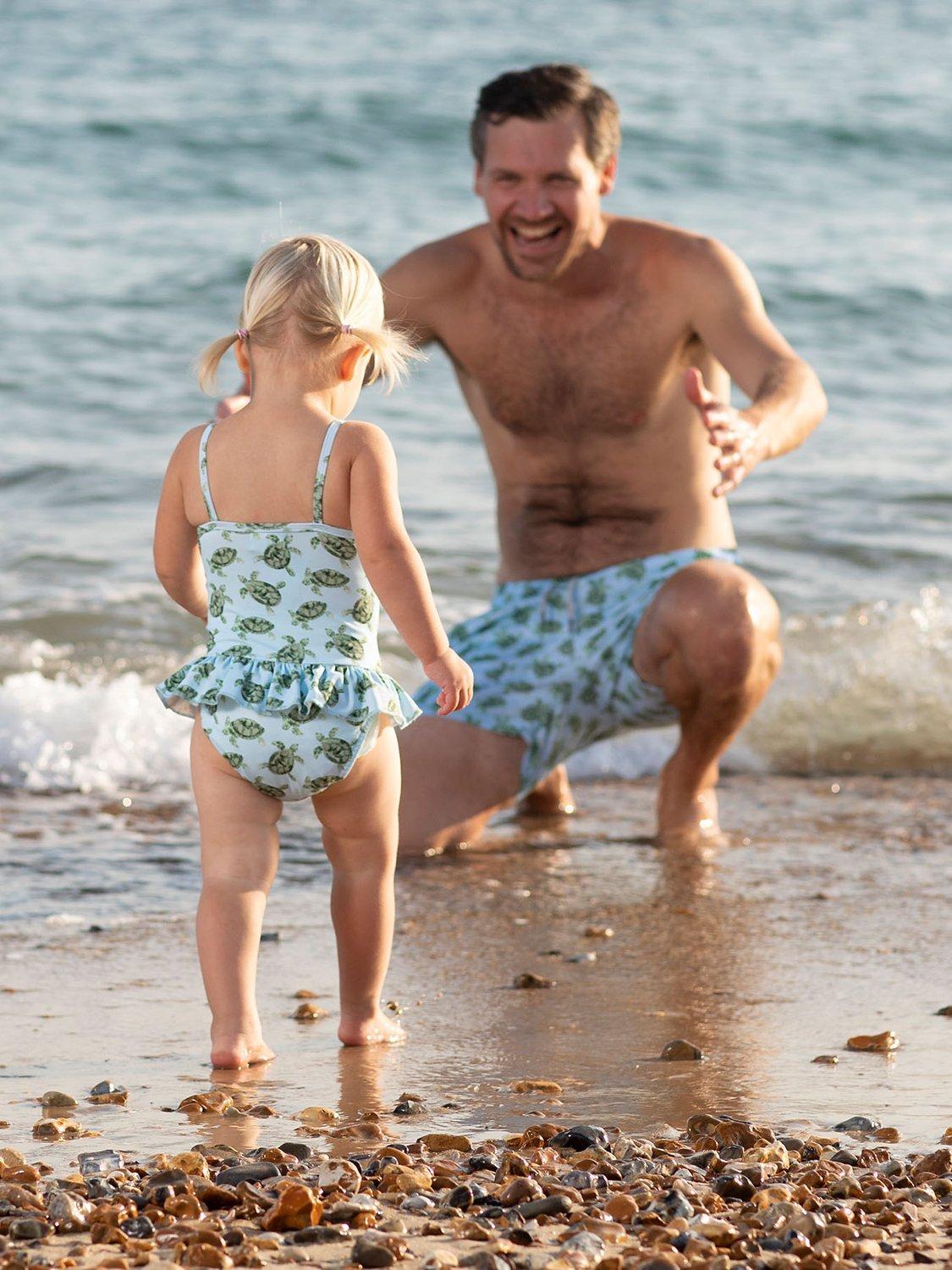 Product image 5 of 6, which shows Trotters Baby Turtle Peplum Swimsuit, Blue, 3-6 months