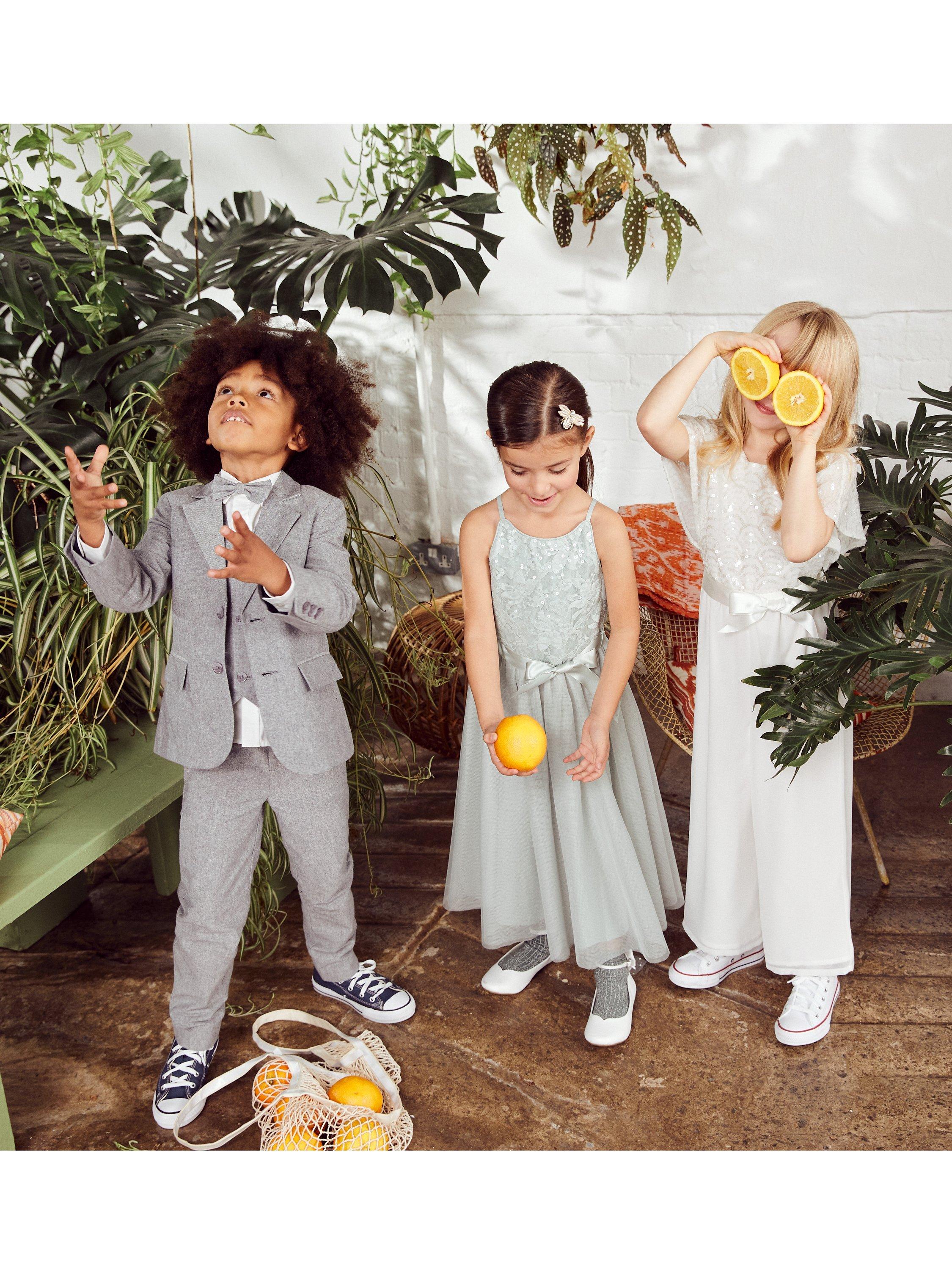 Product image 4 of 5, which shows Monsoon Kids' Truth Deco Cape Sleeve Jumpsuit, Ivory, 3-4 years