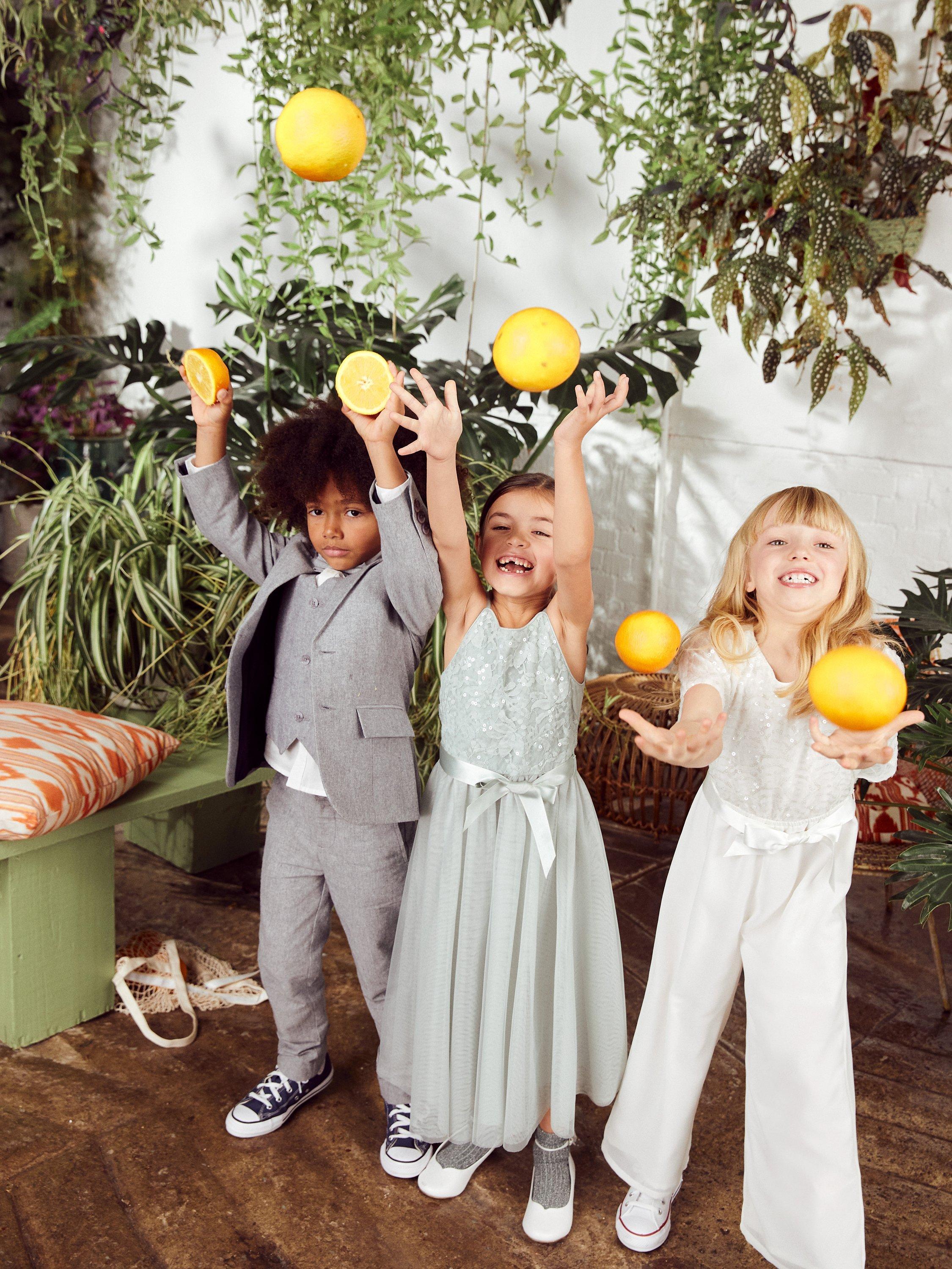 Product image 5 of 5, which shows Monsoon Kids' Truth Deco Cape Sleeve Jumpsuit, Ivory, 3-4 years