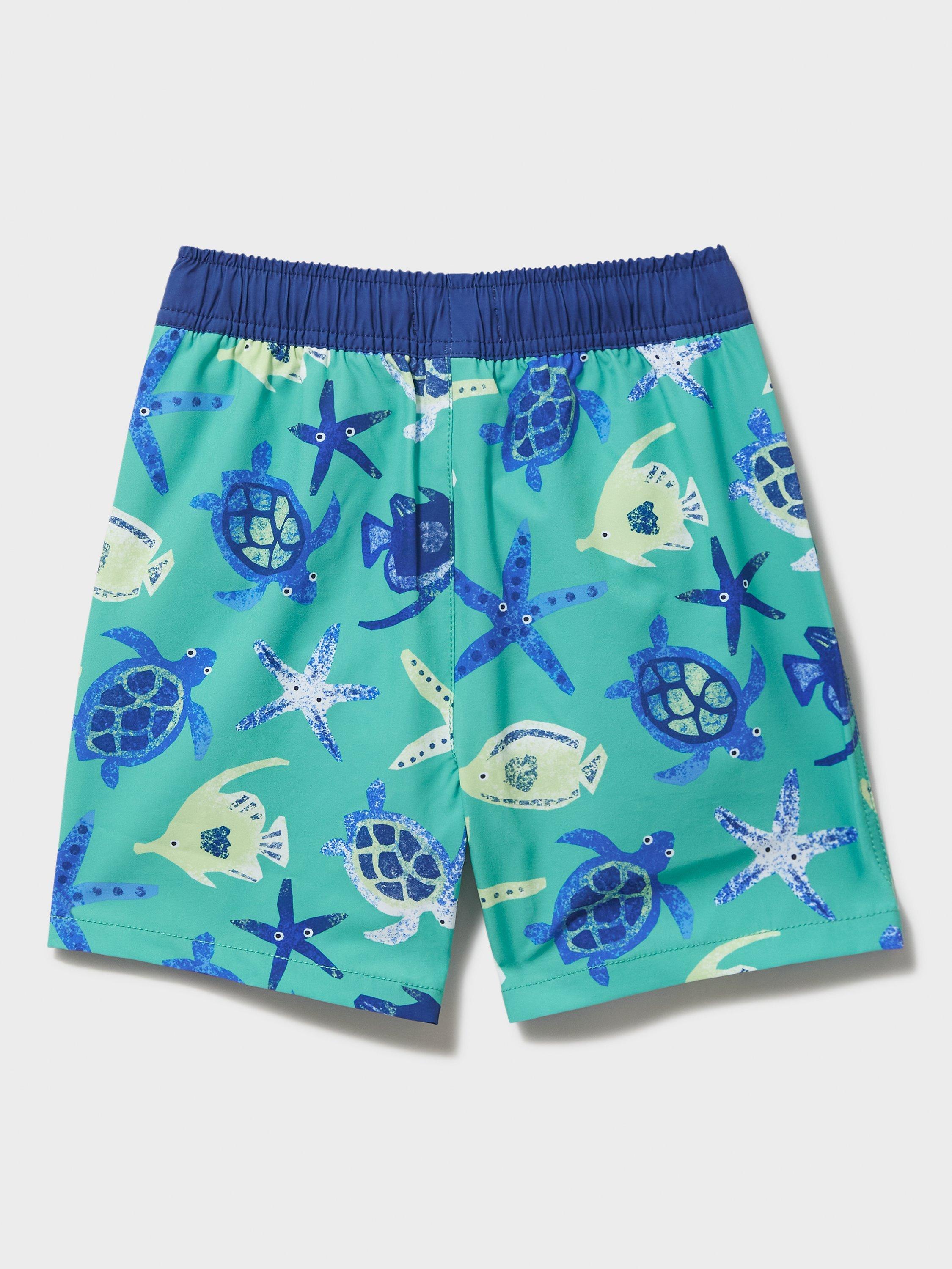 Product image 2 of 3, which shows Crew Clothing Kids' Turtle Swim Shorts, Blue, 3-4 years