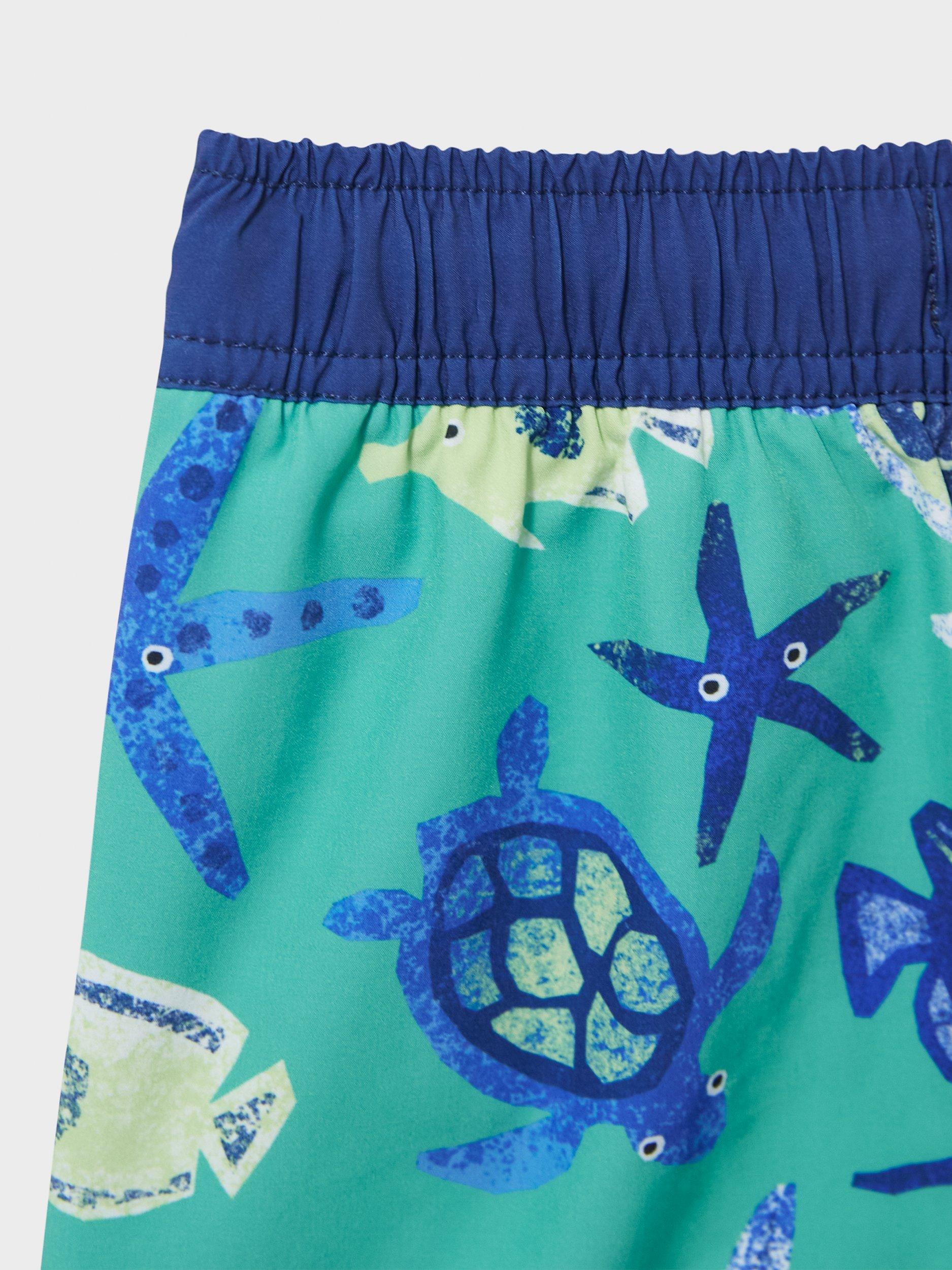 Product image 3 of 3, which shows Crew Clothing Kids' Turtle Swim Shorts, Blue, 3-4 years