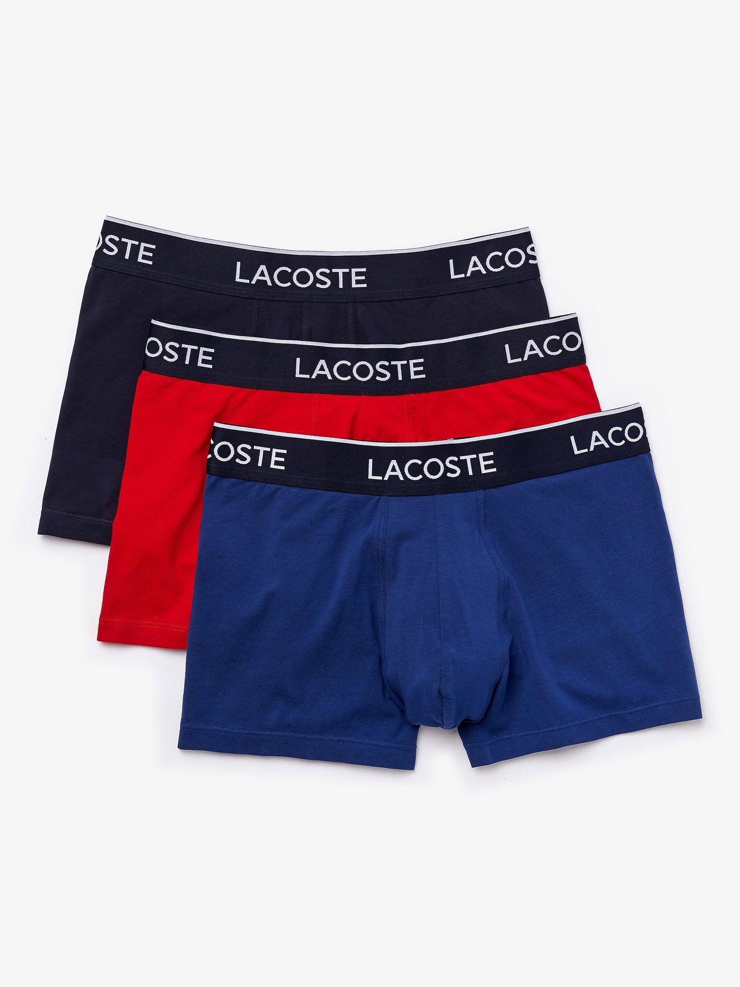 Product image 1 of 4, which shows Lacoste Plain Colour Trunks, Pack of 3, Blue/Red/Black, S
