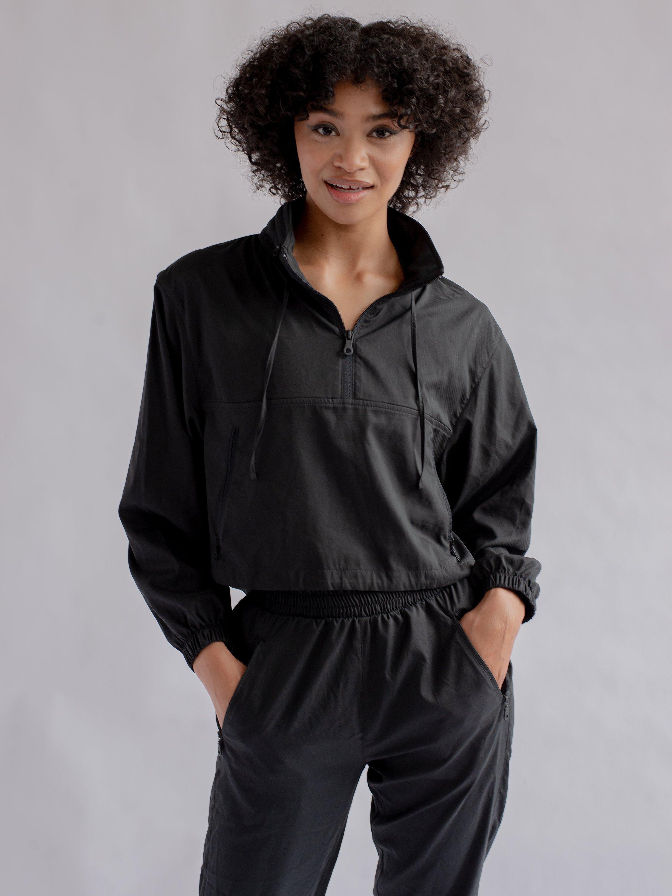 Product image 1 of 6, which shows Girlfriend Collective Hummingbird Half Zip Windbreaker, Black, XS