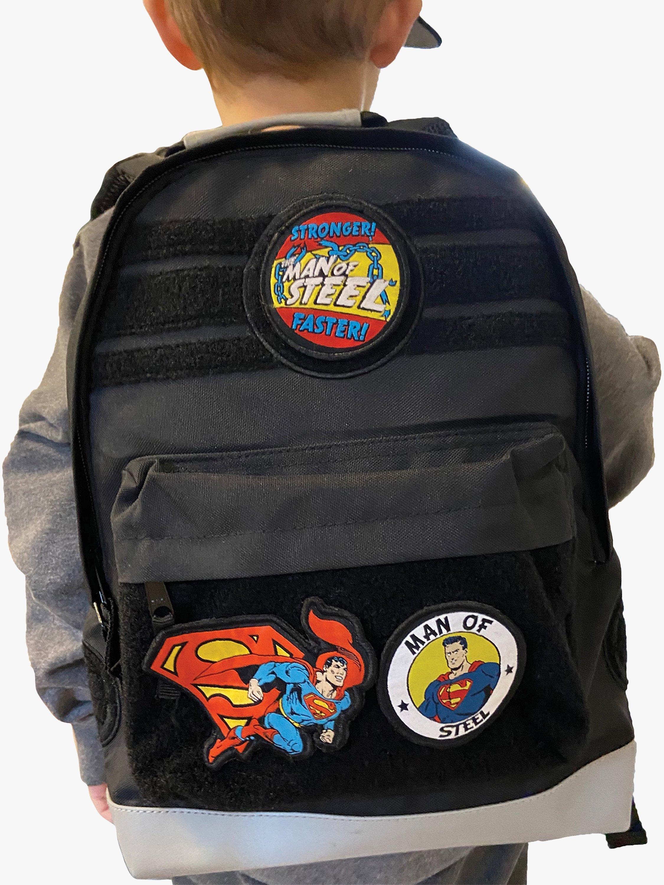 Product image 1 of 3, which shows Fabric Flavours Kids' Superman Interchangeable Badges Backpack, Black, One Size