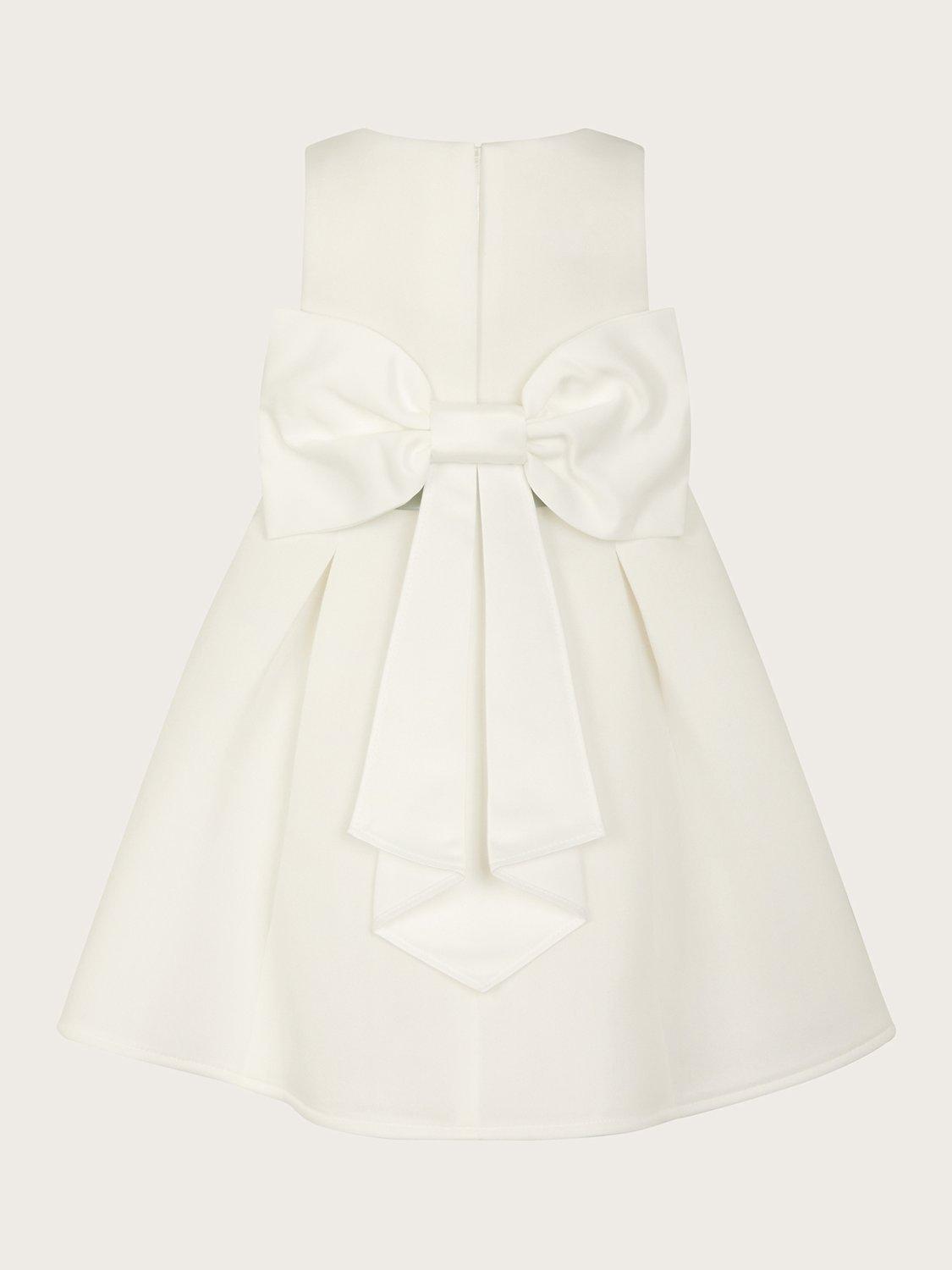 Product image 2 of 3, which shows Monsoon Baby Holly Bow Scuba Bridemaids Dress, Ivory, 0-3 months