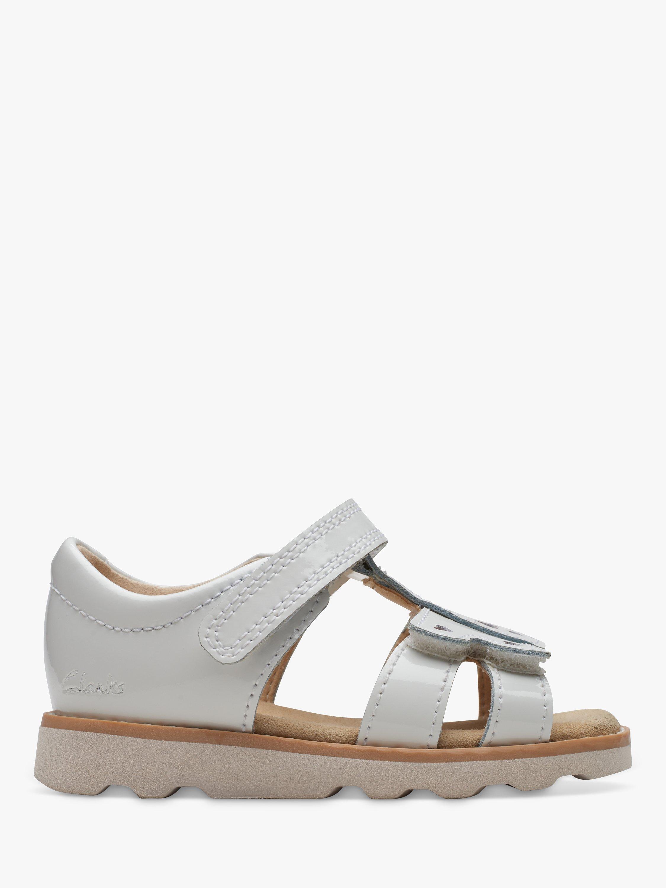 Product image 1 of 7, which shows Clarks Kids' Crown Beat Leather T-Bar Sandals, White Patent, 5 F Jnr