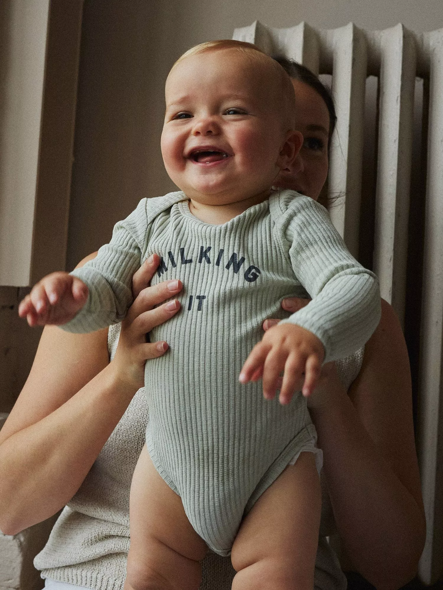 baby boy wearing a blue bodysuit