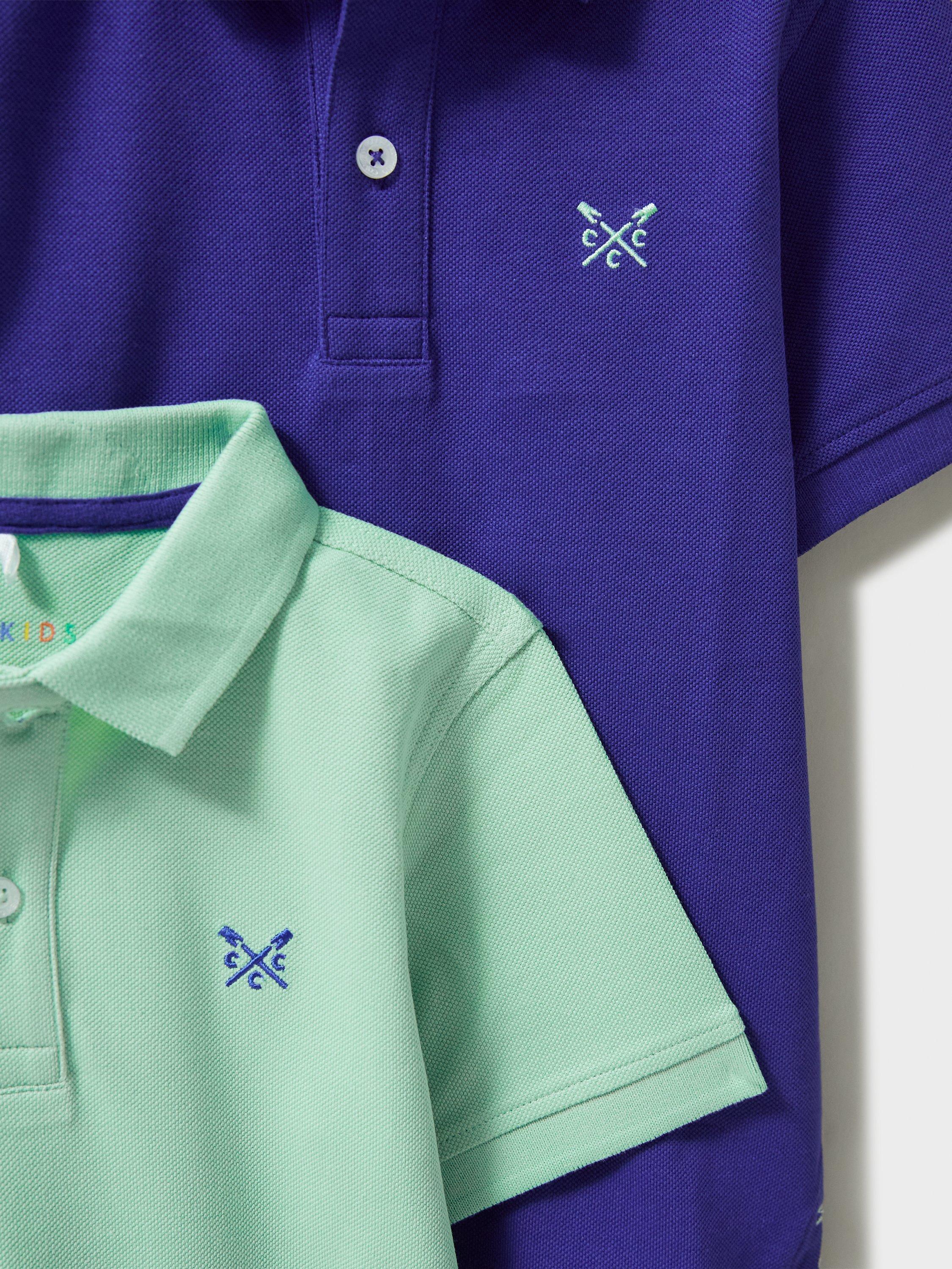 Product image 3 of 3, which shows Crew Clothing Kids' Pique Short Sleeved Polo Shirt, Pack of 2, Green/Blue, 3-4 years