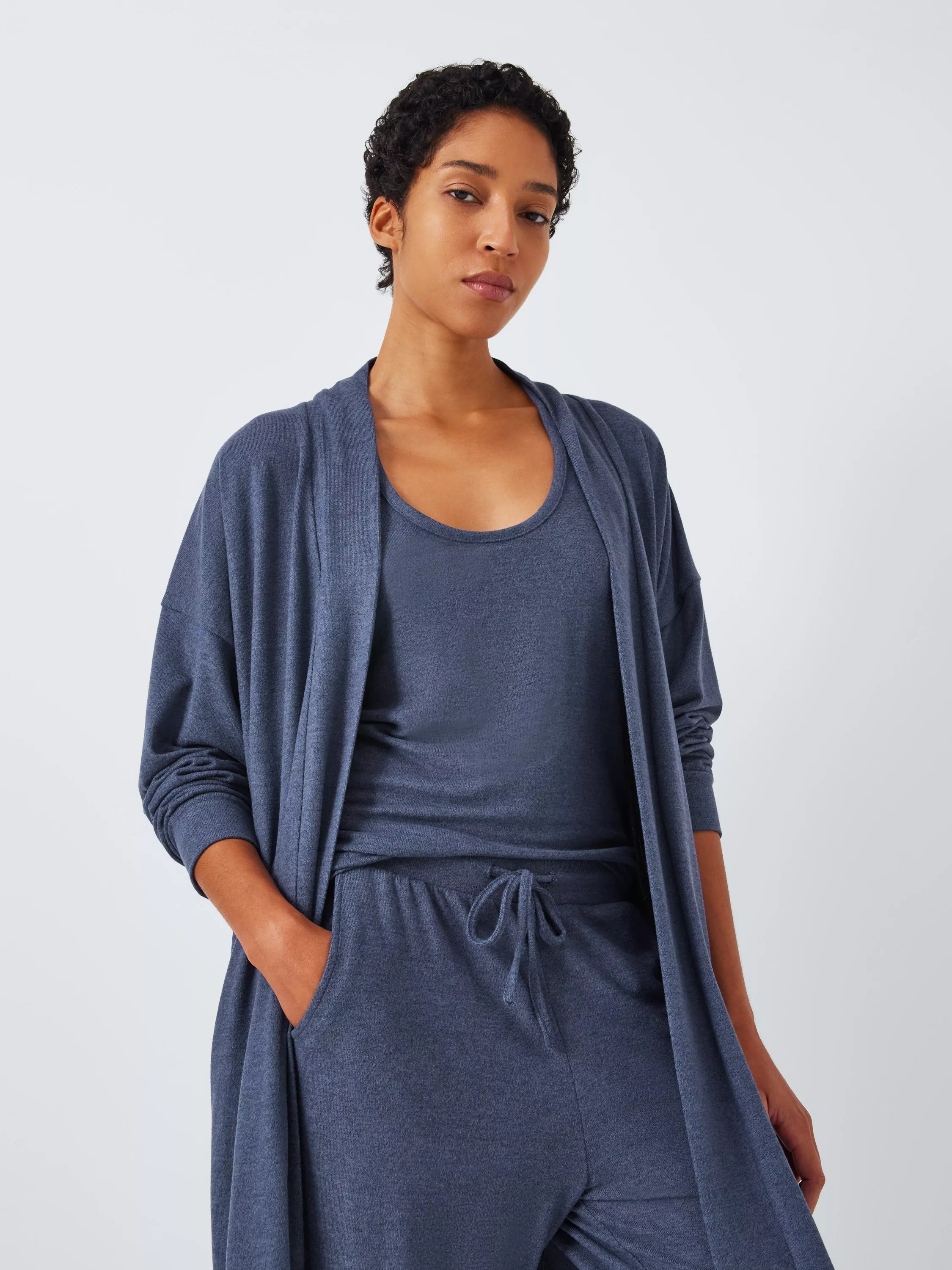 Woman wearing a blue pyjama set and robe