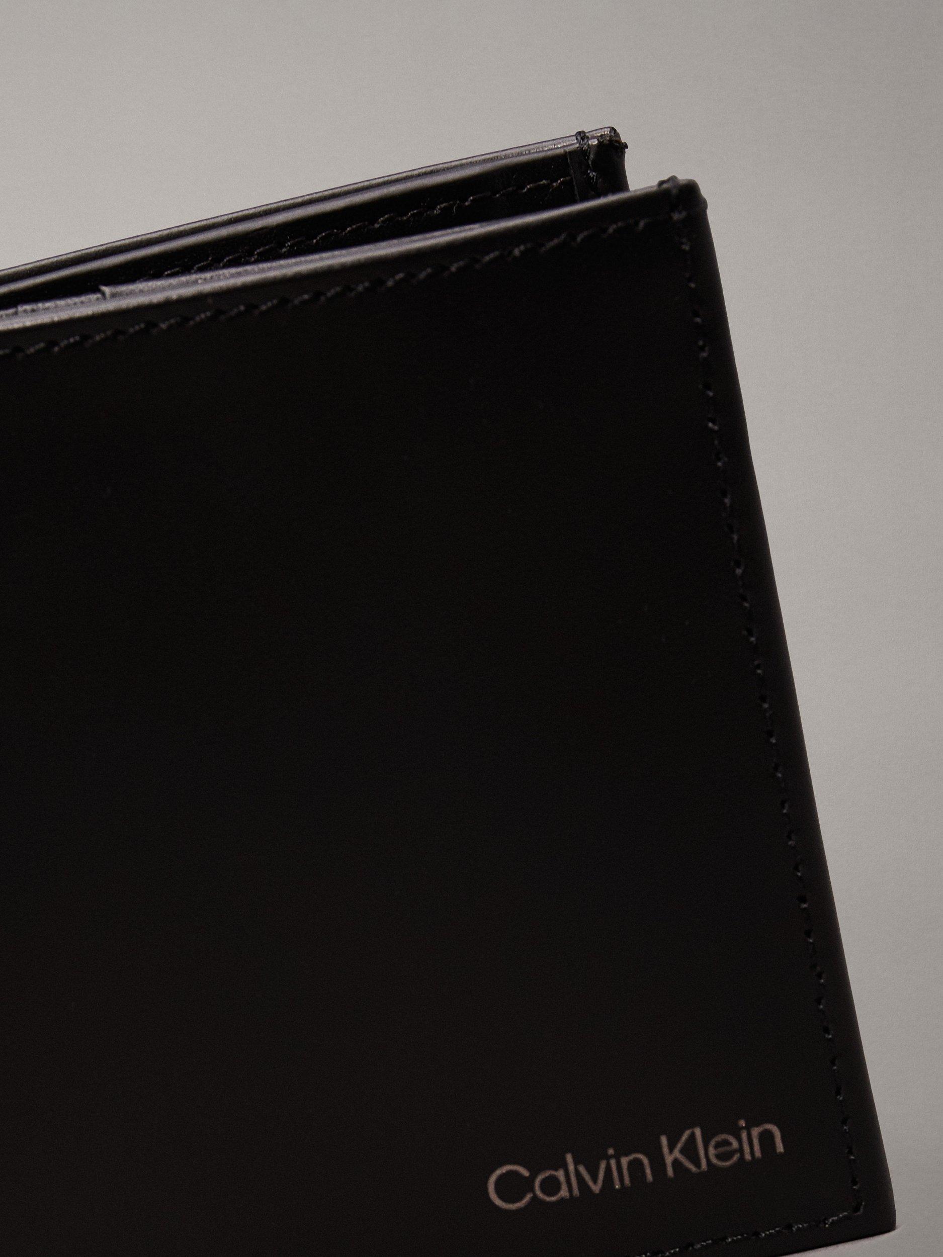 Product image 4 of 5, which shows Calvin Klein Smooth Leather Trifold Wallet, Ck Black