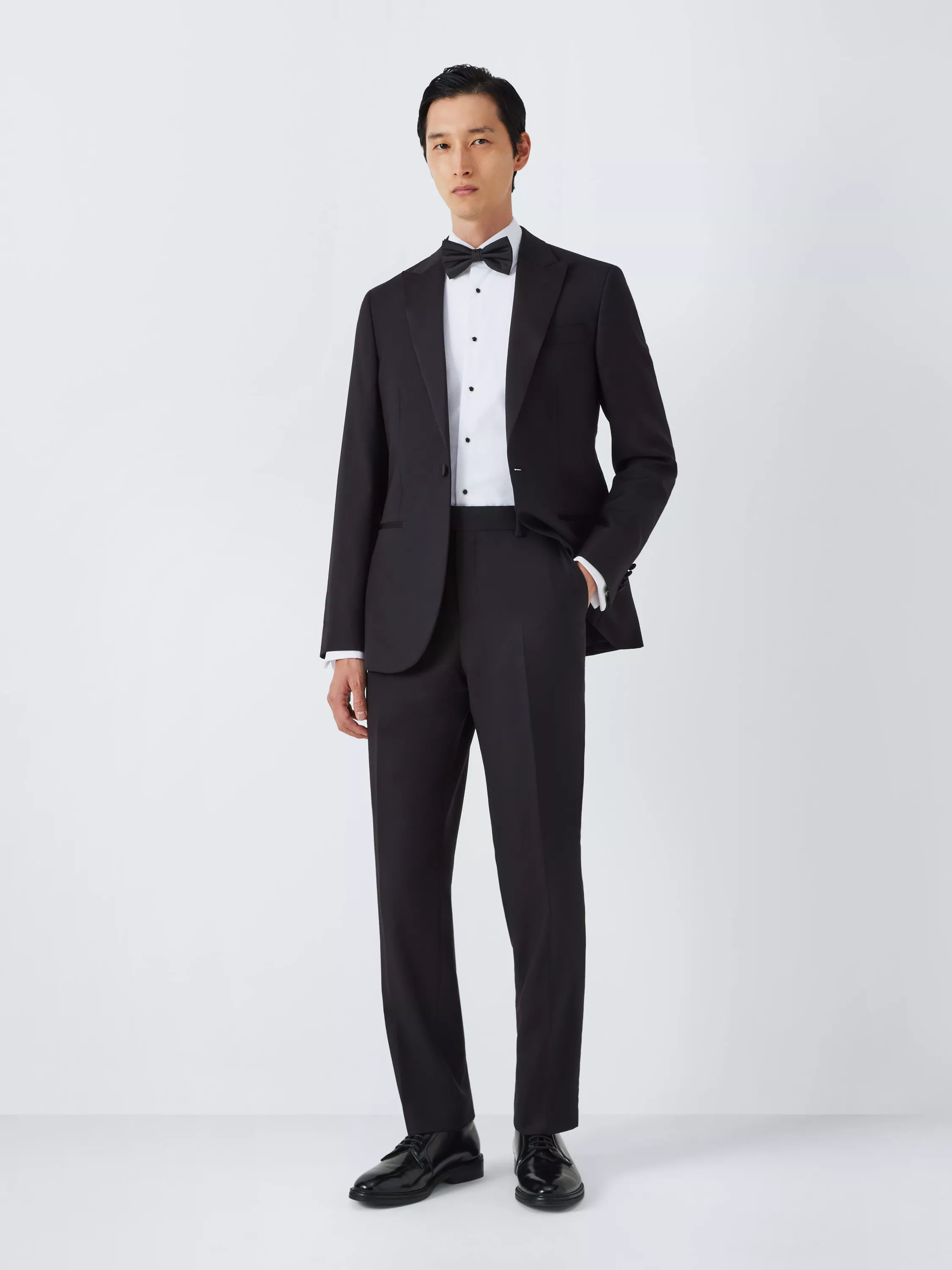 Man wearing formal black tie tailored suit