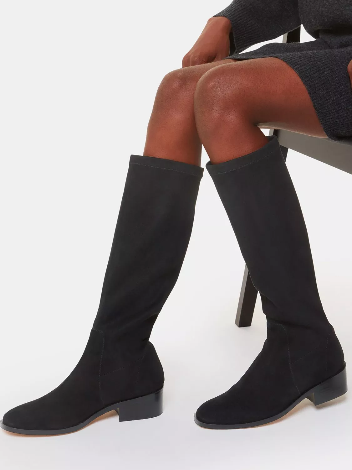 woman wearing black knee high boots
