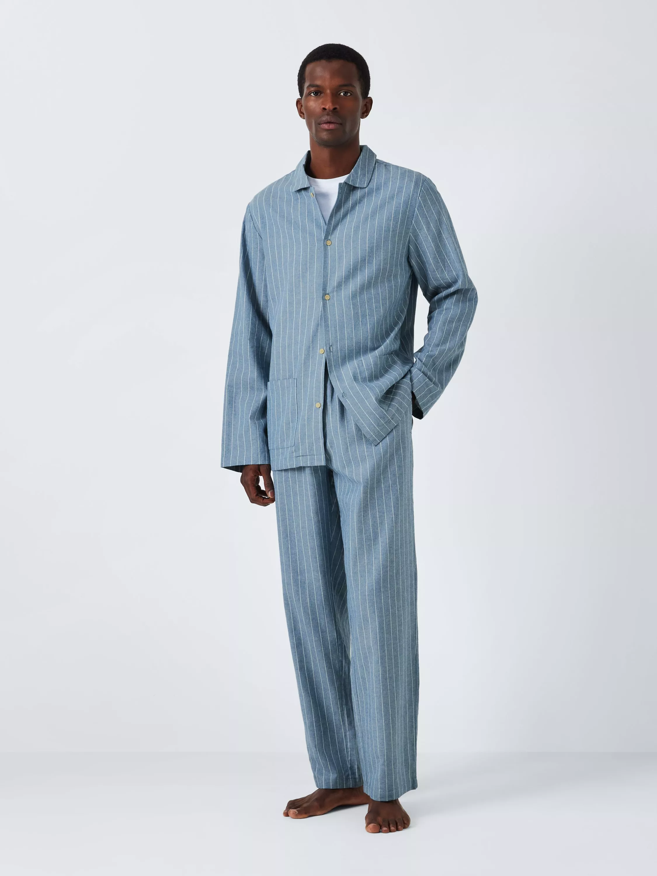 A person wearing a heavy-weight, slate-blue robe with a large dark charcoal windowpane check pattern.