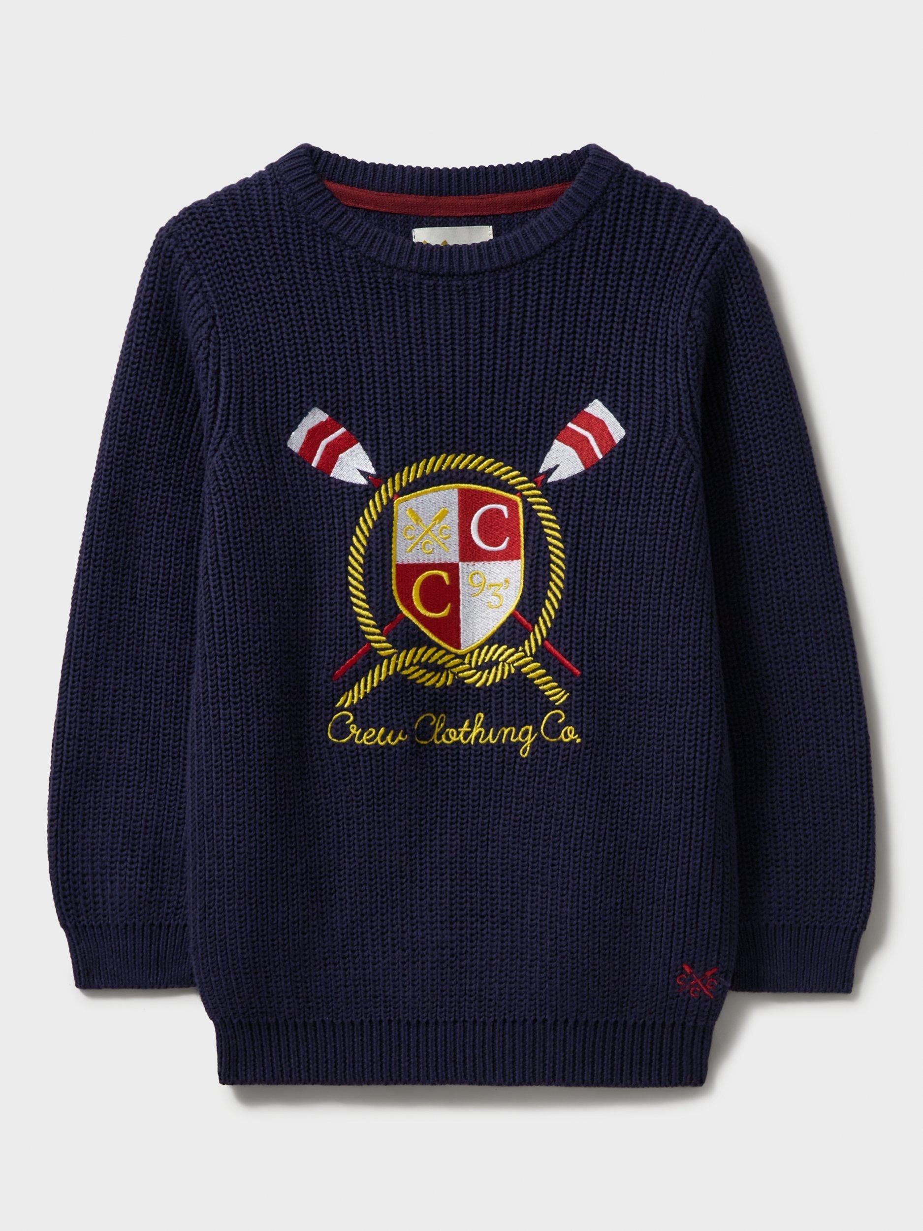 Product image 1 of 3, which shows Crew Clothing Kids' Embroidered Crest Logo Jumper, Navy/Multi, 8-9 years