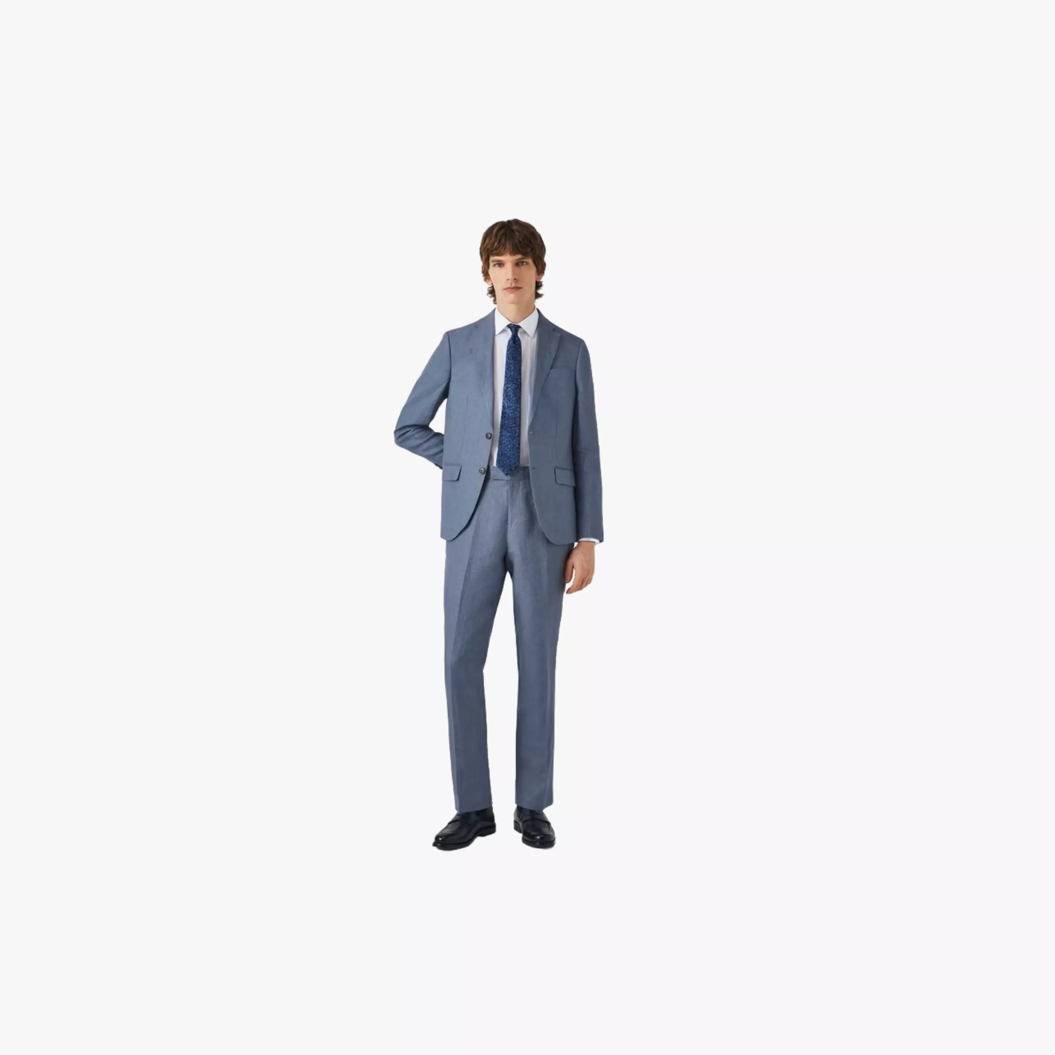 Full-length studio photo of man wearing navy business suit, striped tie and black shoes on white background