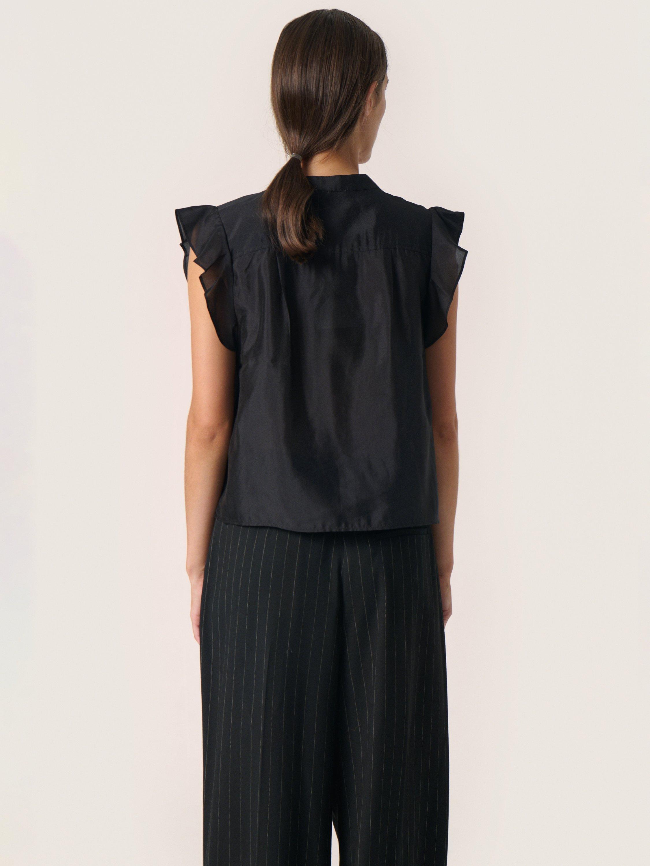 Product image 2 of 6, which shows Soaked In Luxury Karoline Frill Sleeve Top, Black, M