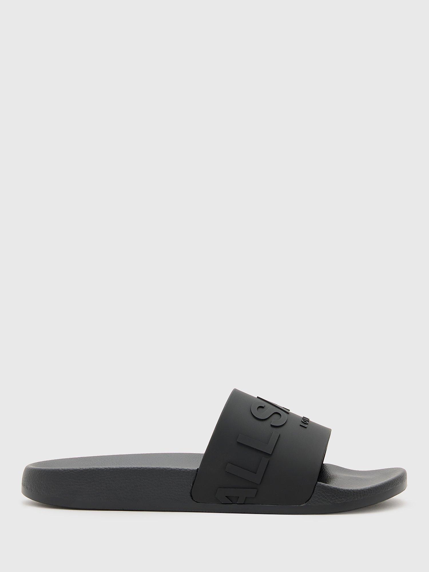 Product image 1 of 5, which shows AllSaints Biggy Slip On Logo Sliders, Black, EU44