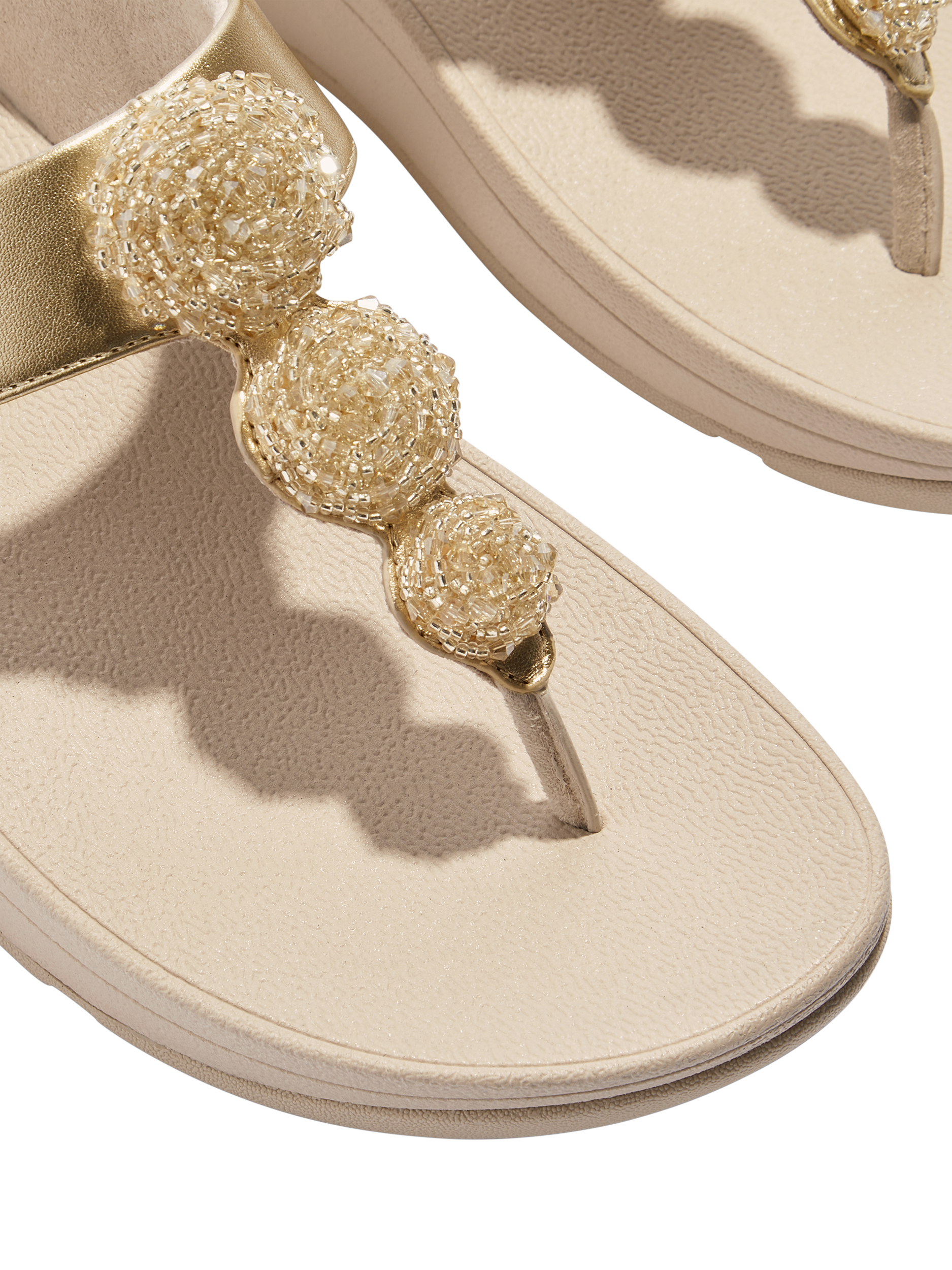 Product image 3 of 4, which shows FitFlop Fino Beaded Button Sandals, Gold, 3