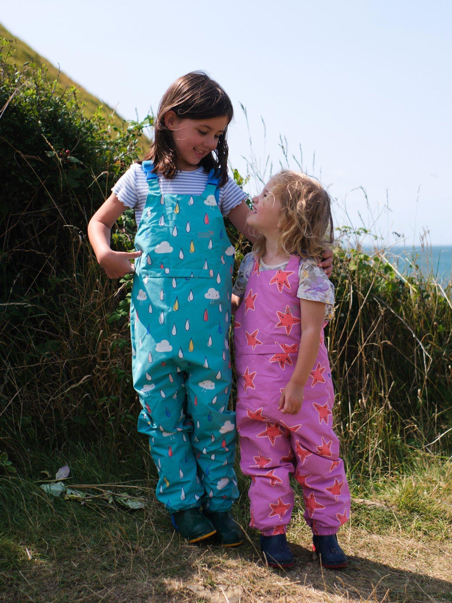 Product image 4 of 6, which shows Muddy Puddles Kids' EcoLight Waterproof Lightweight Star Dungarees, Pink/Multi, 12-18 months