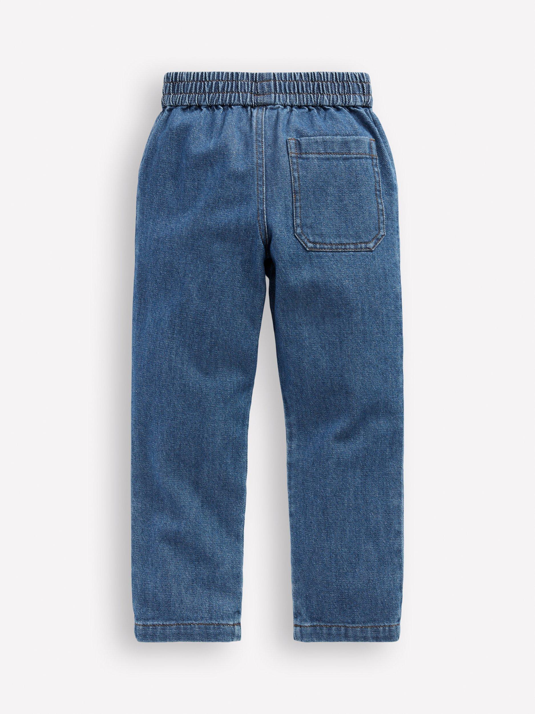 Product image 2 of 3, which shows Mini Boden Girl's Daisy Pocket Pull-On Denim Trousers, Embroidered Daisy, 2-3 years