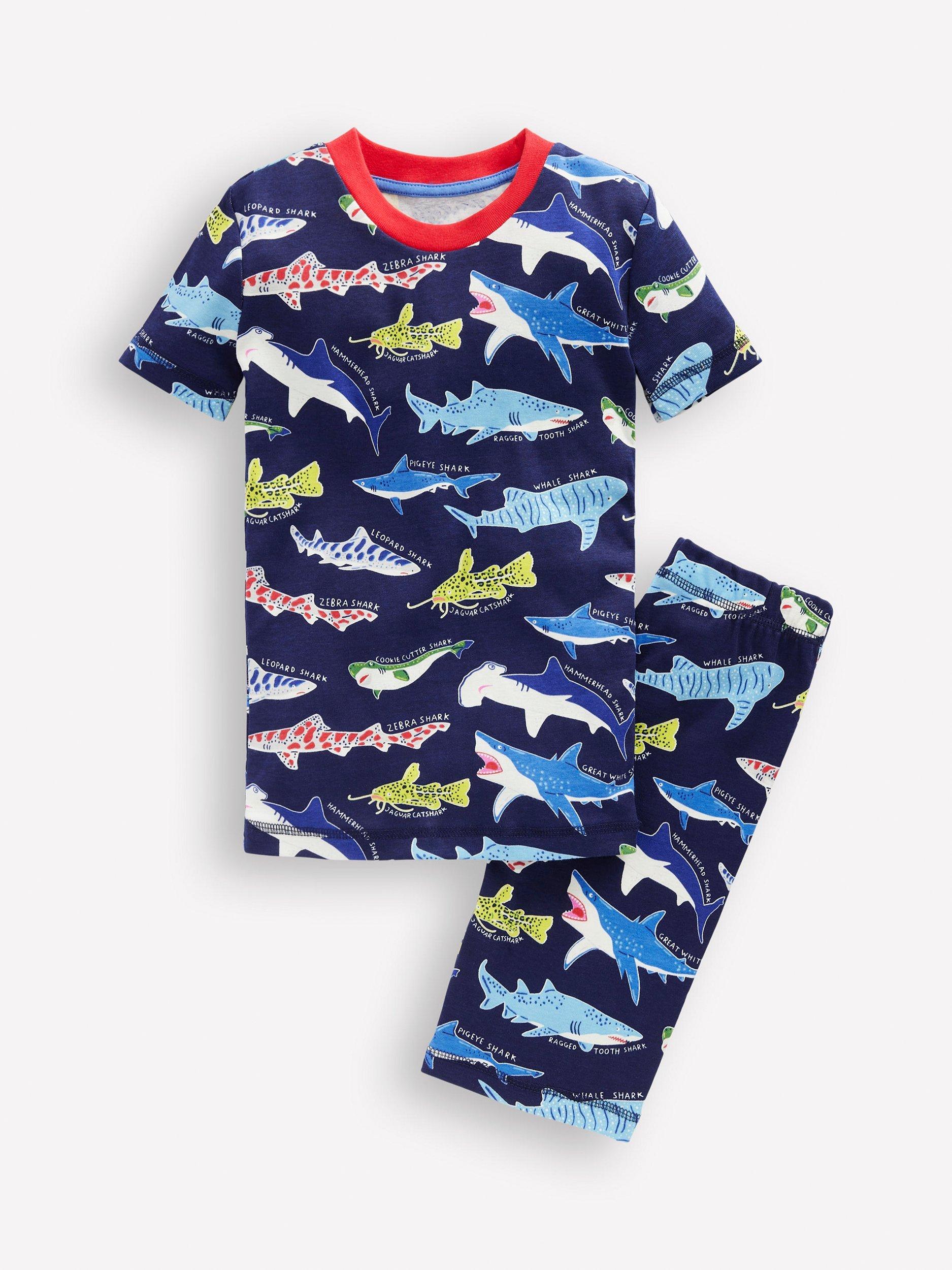 Product image 1 of 3, which shows Mini Boden Kids' Cotton Glow-in-th-Dark Short John Pyjamas, College Navy Sharks, 2 years