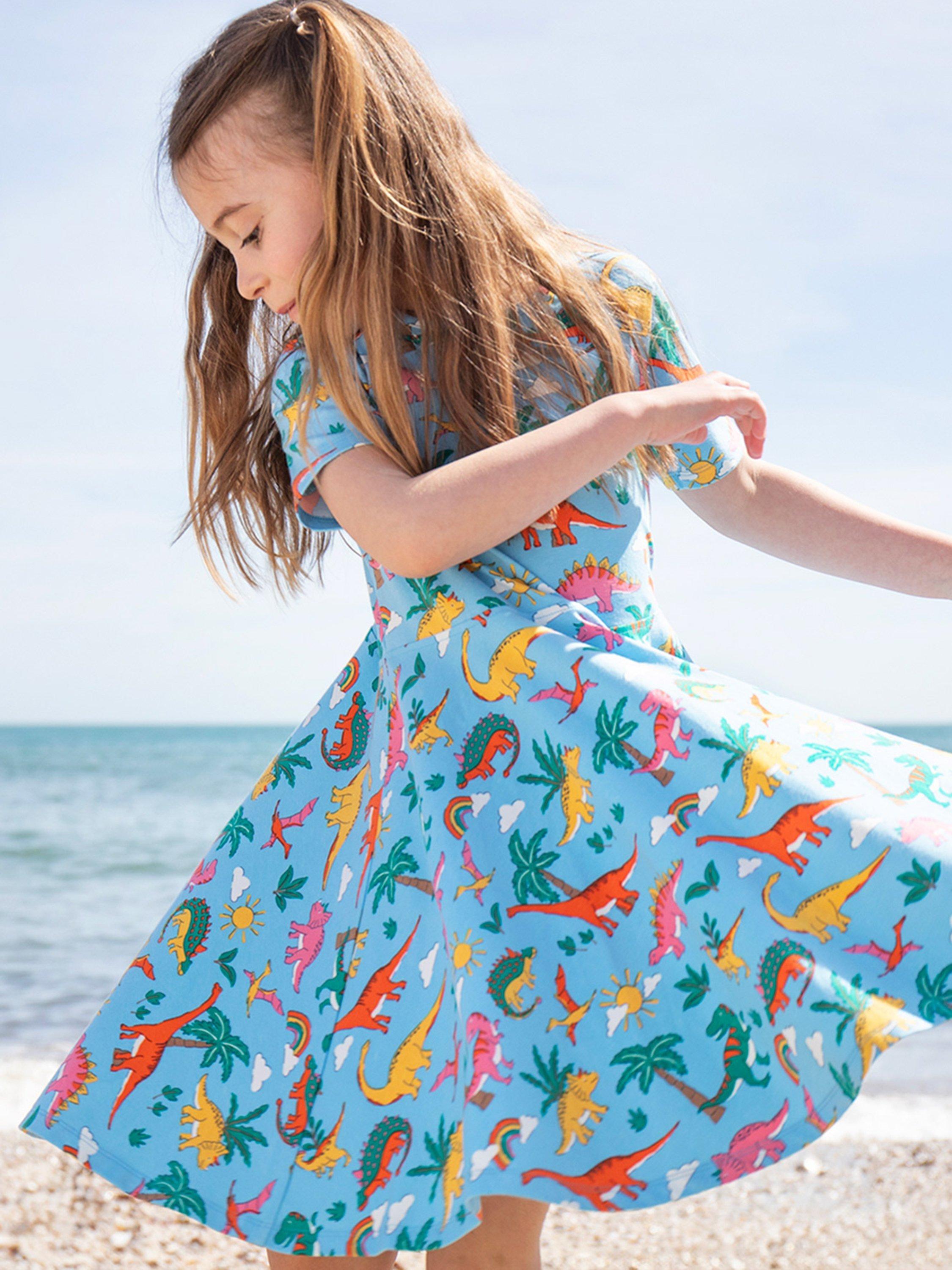 Product image 2 of 5, which shows Frugi Kids' Sunshine Organic Cotton Dinosaur Skater Dress, Blue, 2-3 years