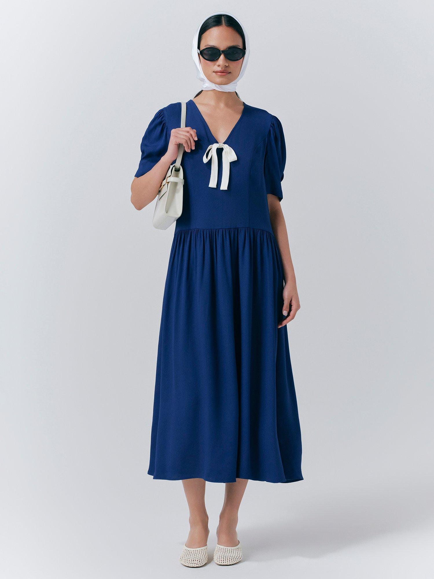 Product image 1 of 5, which shows Ghost Peoni Bow Detail Midi Dress, Dark Blue, XS
