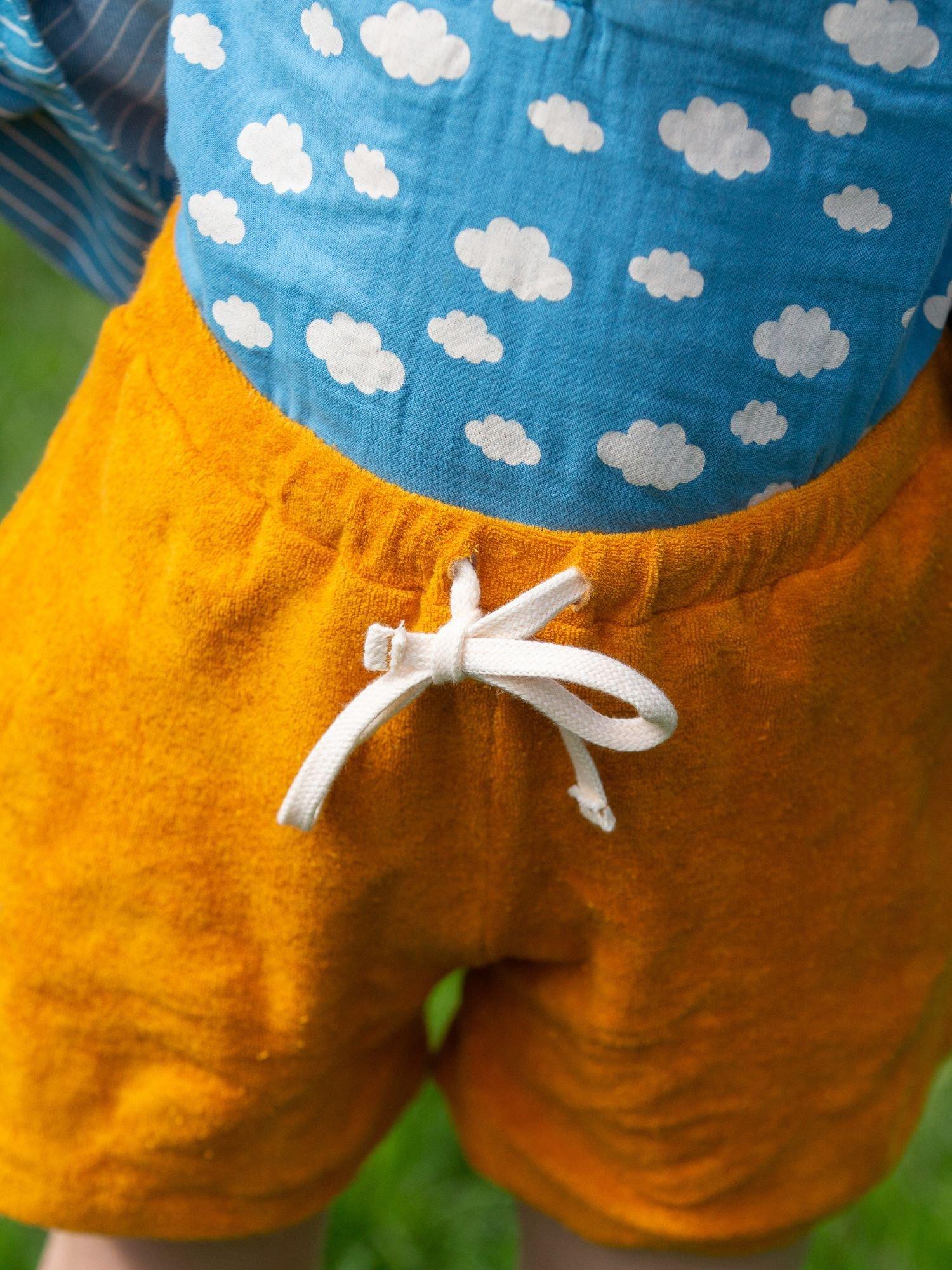Product image 4 of 5, which shows Little Green Radicals Kids' Pure Organic Cotton Towelling Shorts, Gold, 2-3 years