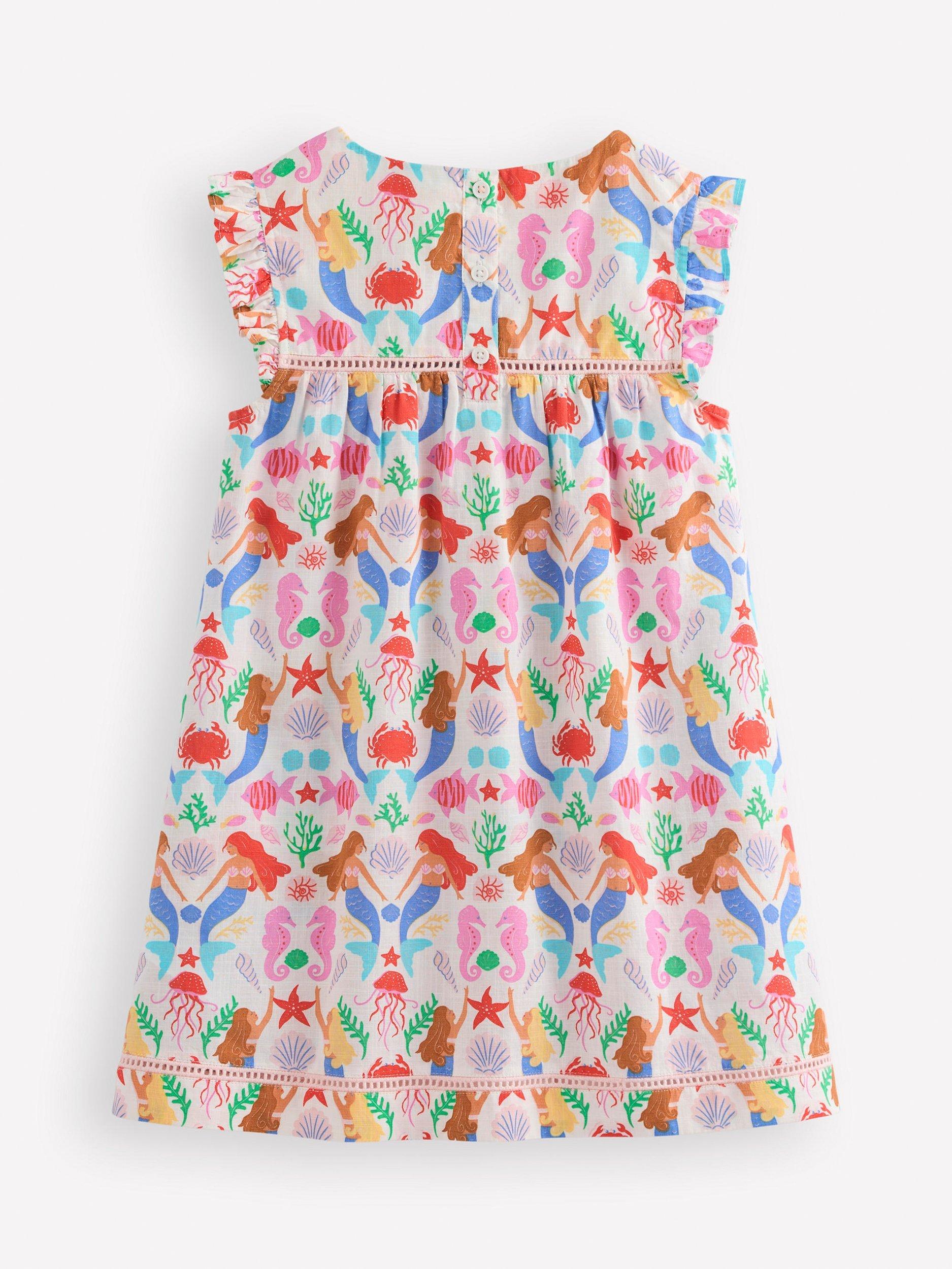 Product image 2 of 3, which shows Mini Boden Kids' Celia Woven Cotton Holiday Dress, Ivory Mermaids, 11-12 years