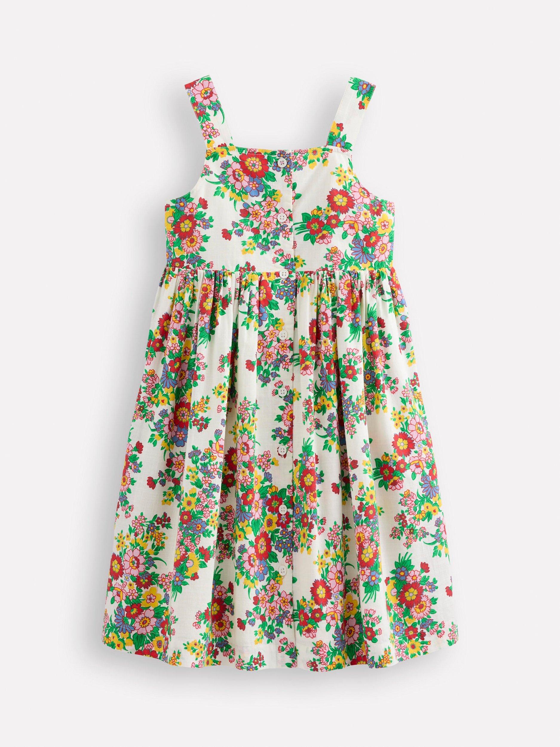Product image 1 of 3, which shows Mini Boden Kids' Remy Button Through Cotton Pinafore Dress, Ivory Flower Bunch, 3-4 years