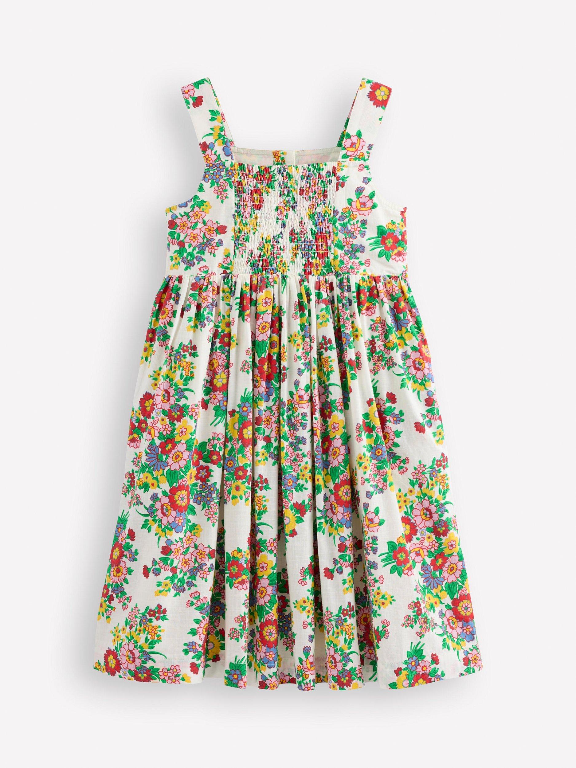 Product image 2 of 3, which shows Mini Boden Kids' Remy Button Through Cotton Pinafore Dress, Ivory Flower Bunch, 3-4 years