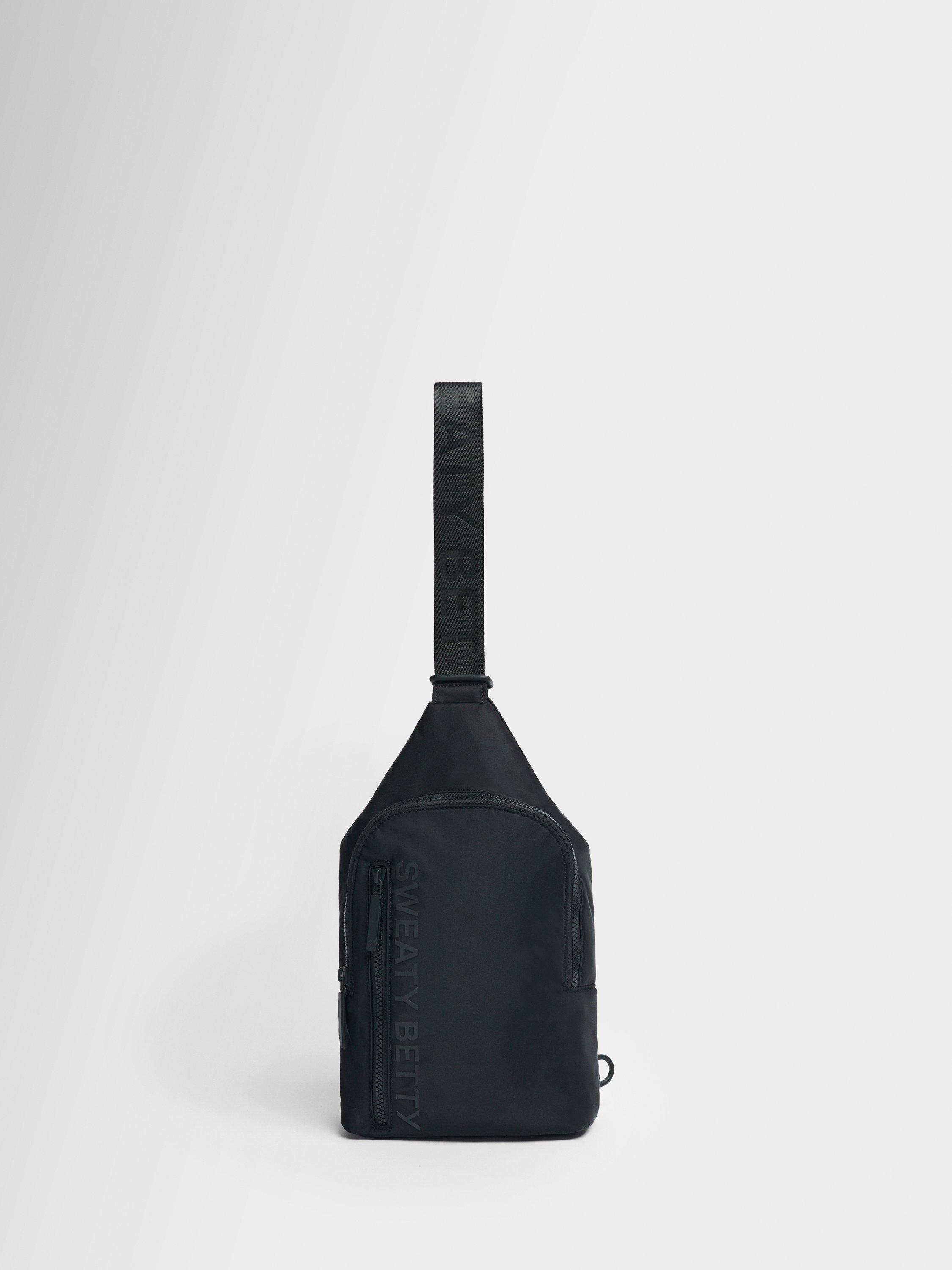 Product image 1 of 5, which shows Sweaty Betty Motion Sling Bag, Black
