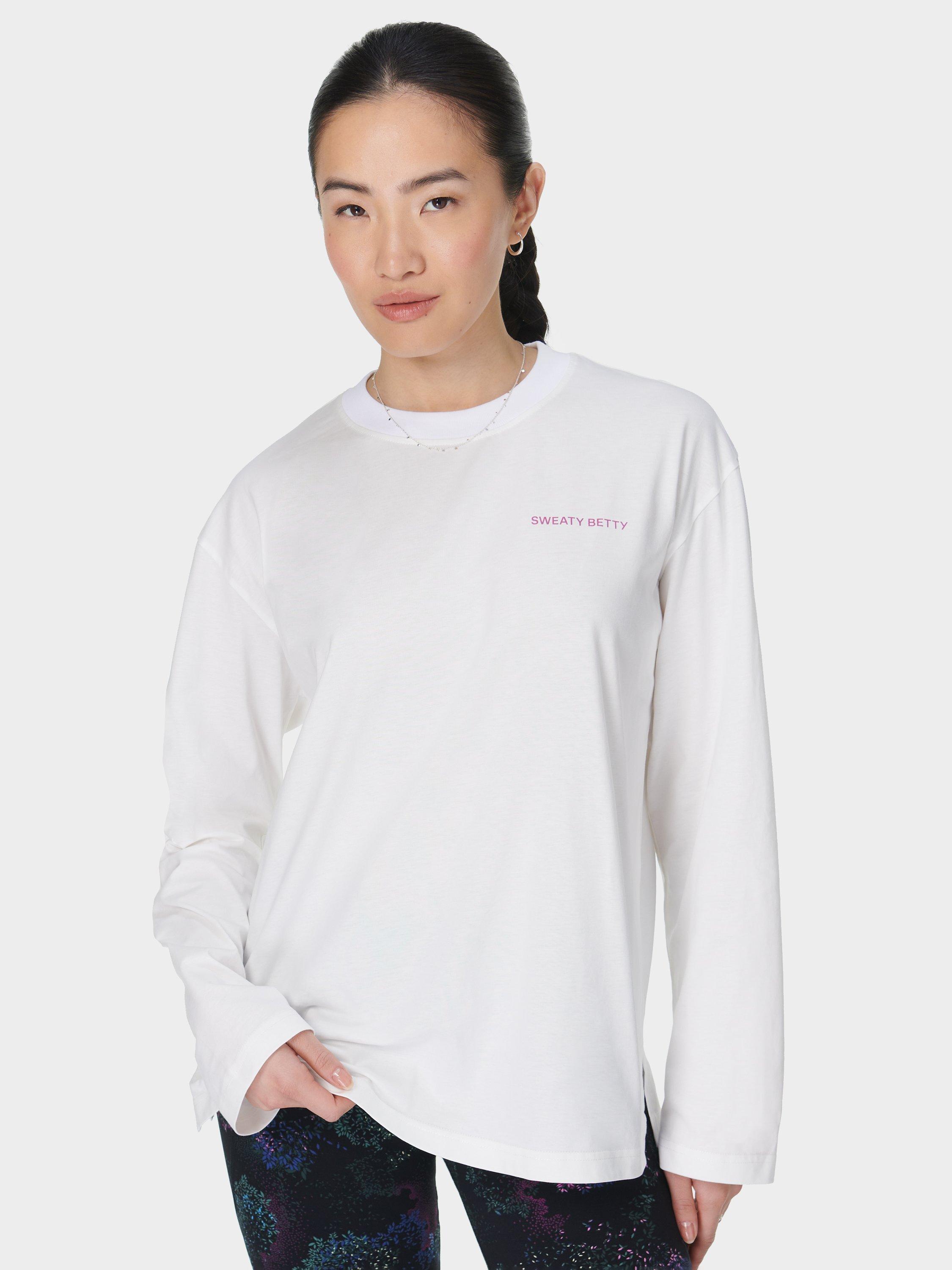 Product image 1 of 7, which shows Sweaty Betty Logo Pure Organic Cotton Long Sleeve Top, Lily White, XXS