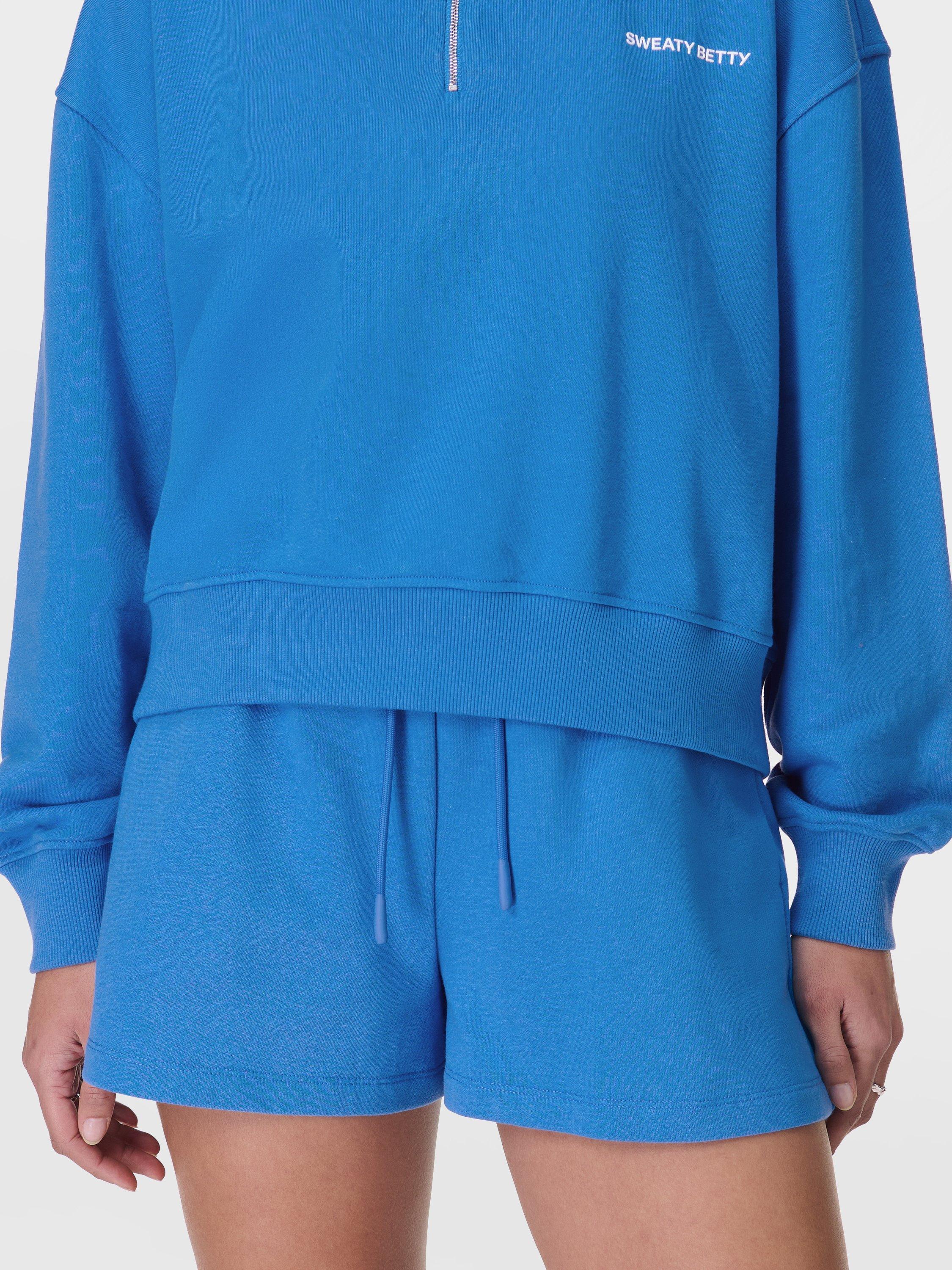 Product image 1 of 7, which shows Sweaty Betty Revive Boxy Organic Cotton Rich Shorts, Tidal Blue, M