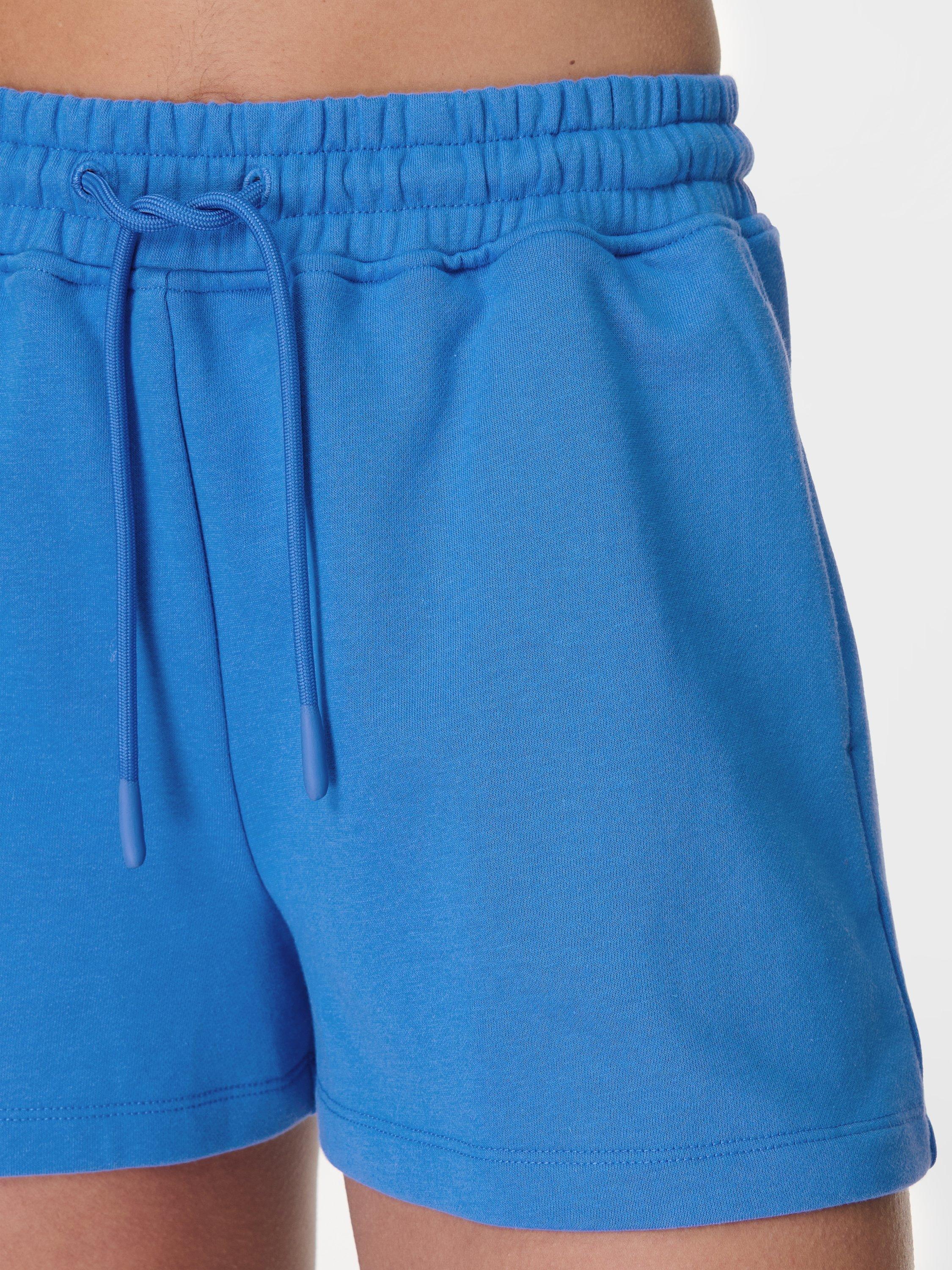 Product image 6 of 7, which shows Sweaty Betty Revive Boxy Organic Cotton Rich Shorts, Tidal Blue, M