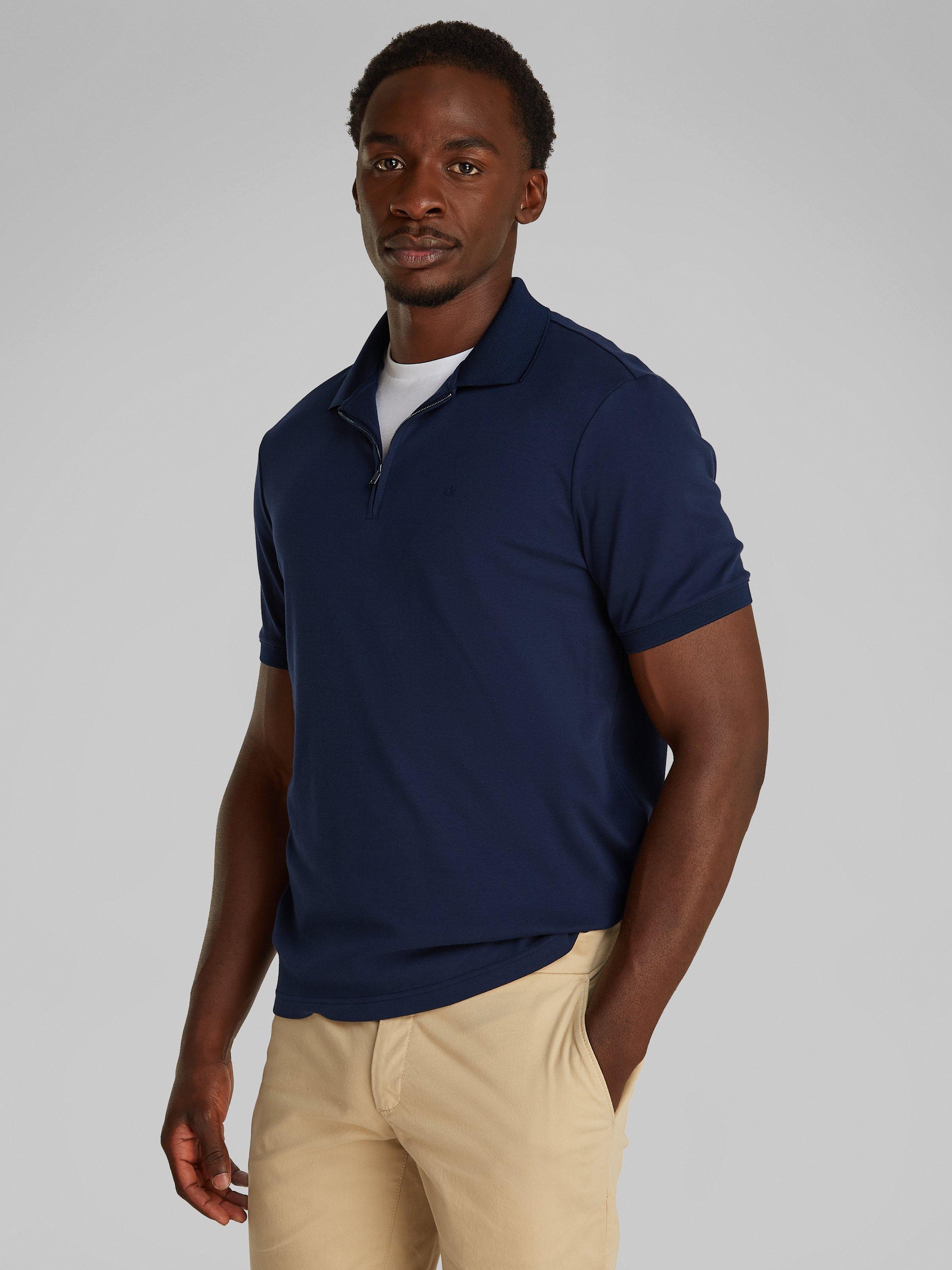 Product image 1 of 6, which shows Calvin Klein Organic Cotton Regular Fit Short Sleeve Zip Neck Polo Shirt, Dark Sapphire, XS