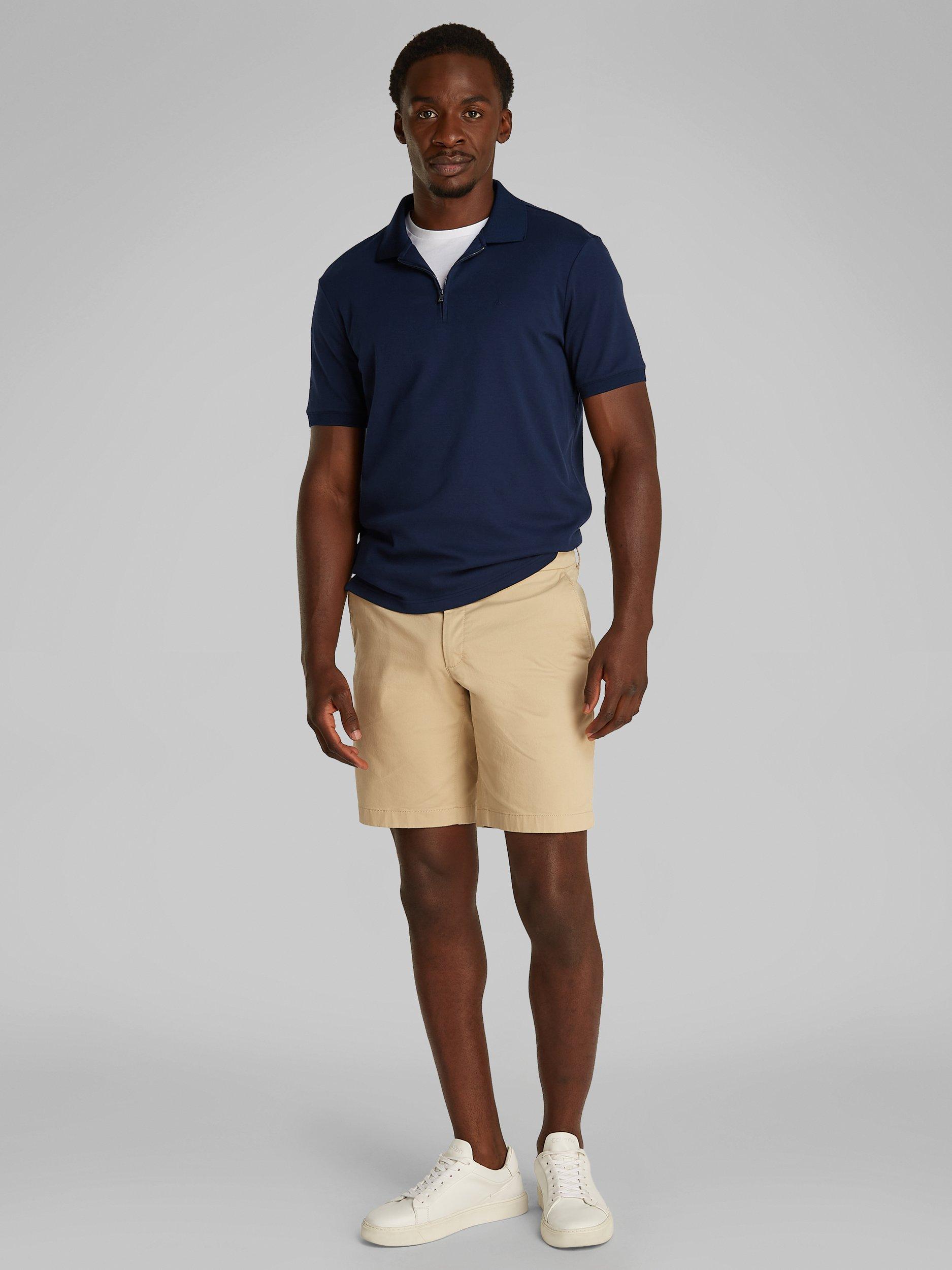 Product image 2 of 6, which shows Calvin Klein Organic Cotton Regular Fit Short Sleeve Zip Neck Polo Shirt, Dark Sapphire, XS