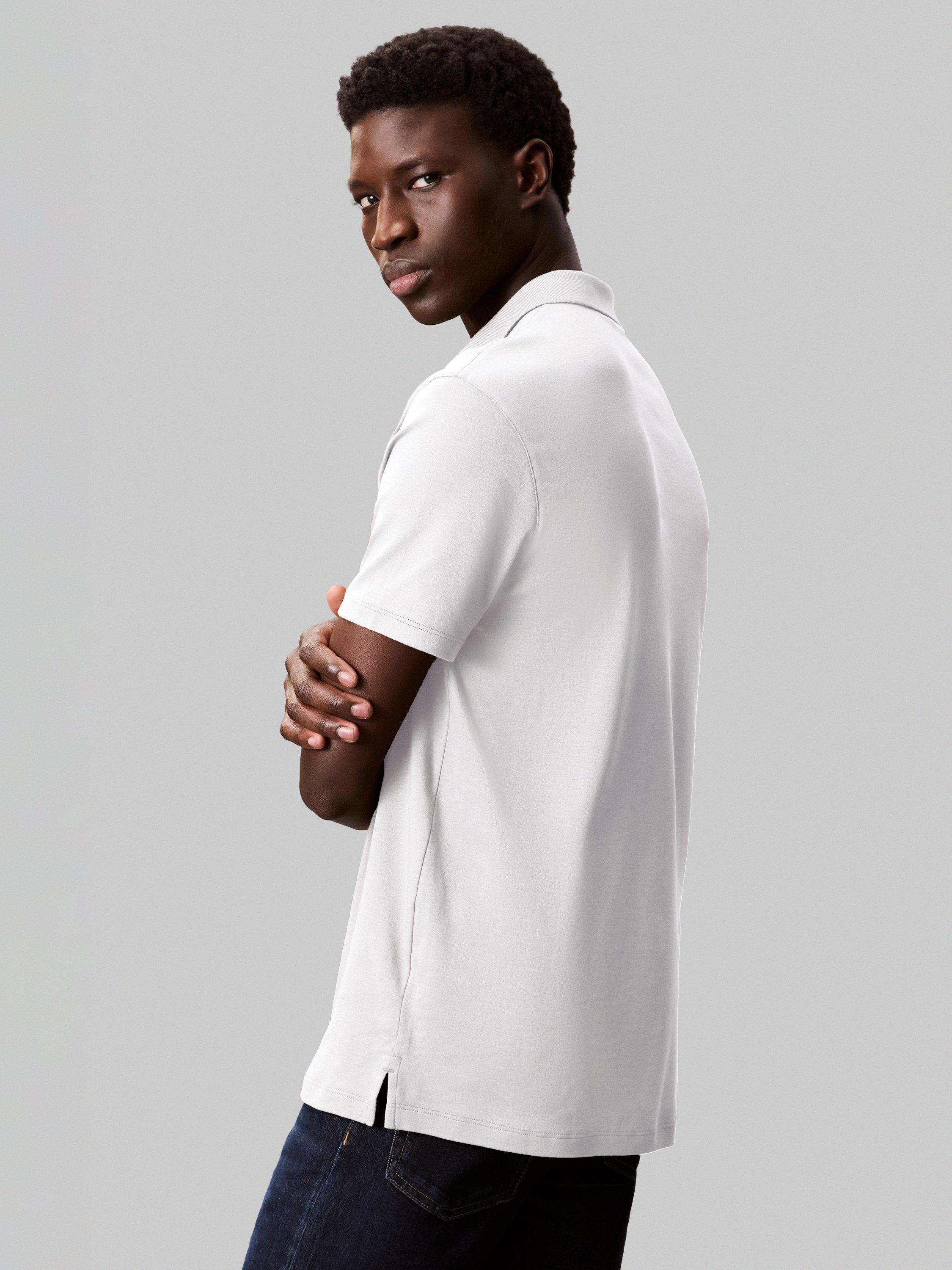 Product image 2 of 4, which shows Calvin Klein Cotton Regular Fit Short Sleeve Logo Polo Shirt, Bright White, XS