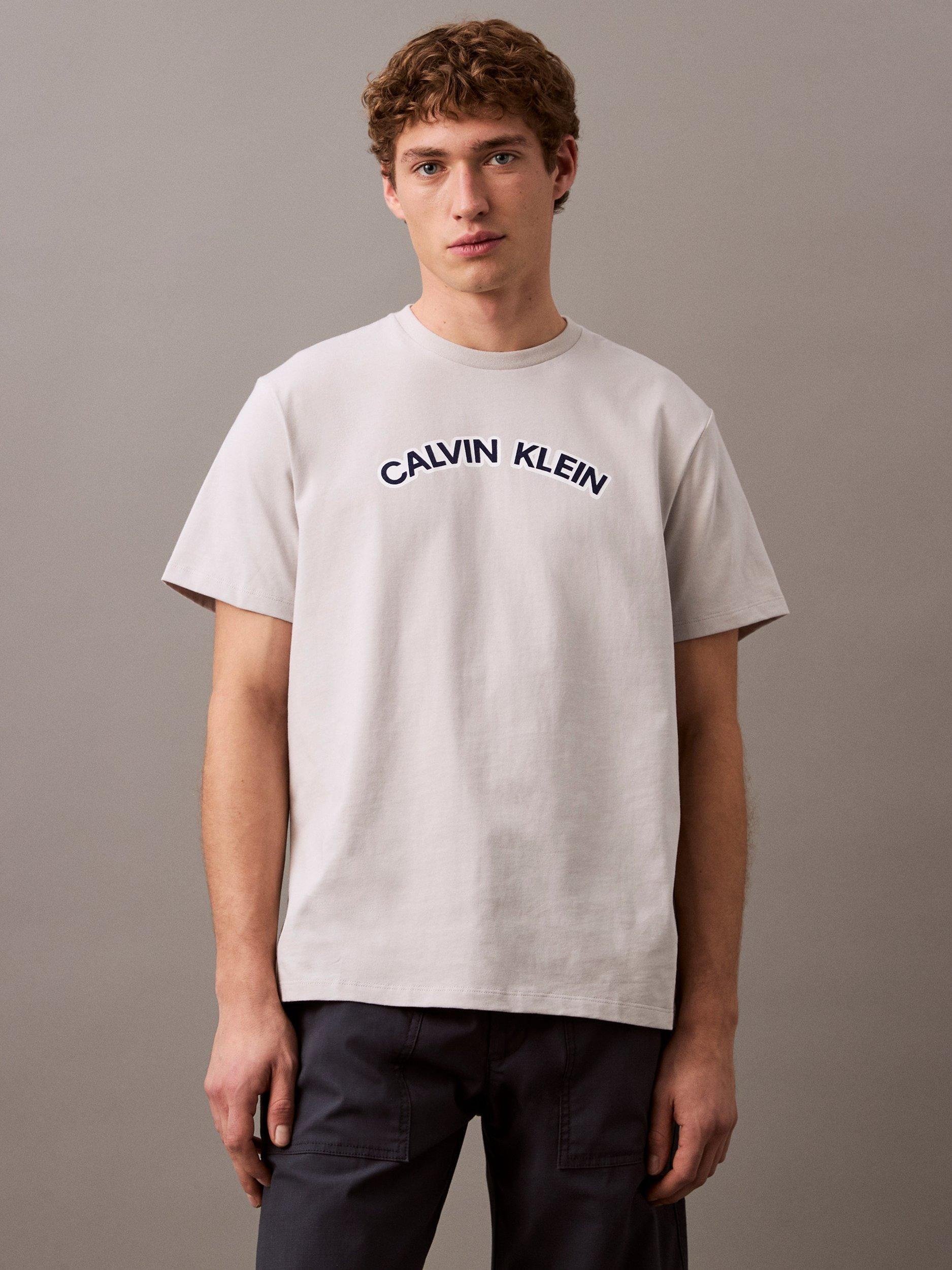 Product image 1 of 4, which shows Calvin Klein Cotton Regular Fit Short Sleeve Curve Logo T-Shirt, Gray Violet, XS
