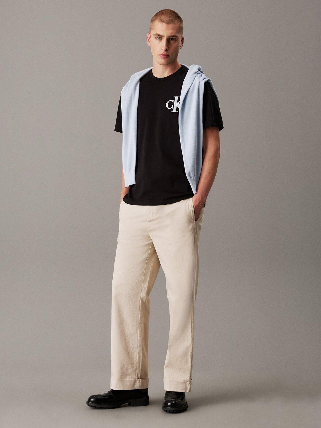 Product image 1 of 4, which shows Calvin Klein Cotton Relaxed Fit Short Sleeve Varsity T-Shirt, Black, XS