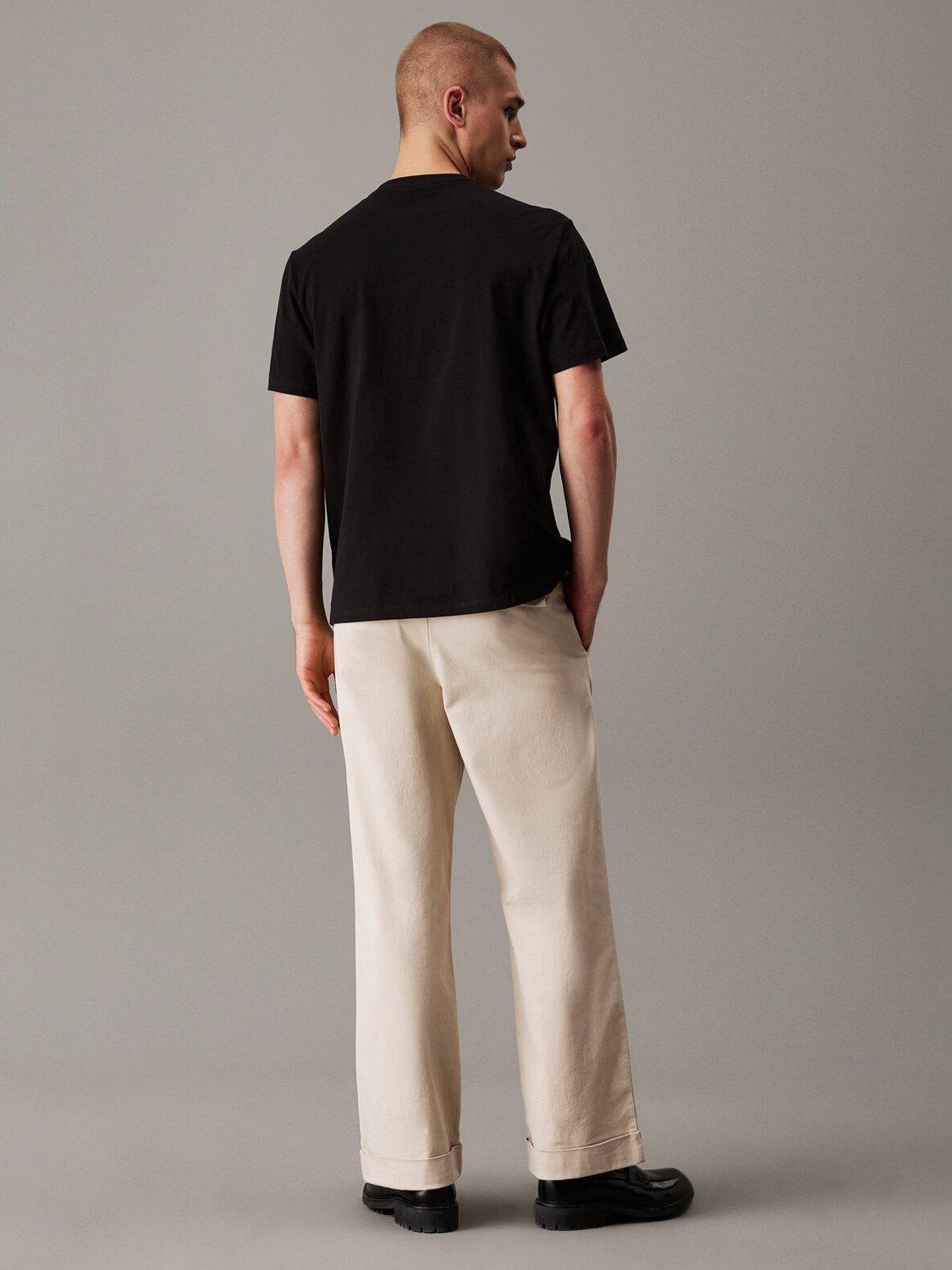 Product image 2 of 4, which shows Calvin Klein Cotton Relaxed Fit Short Sleeve Varsity T-Shirt, Black, XS
