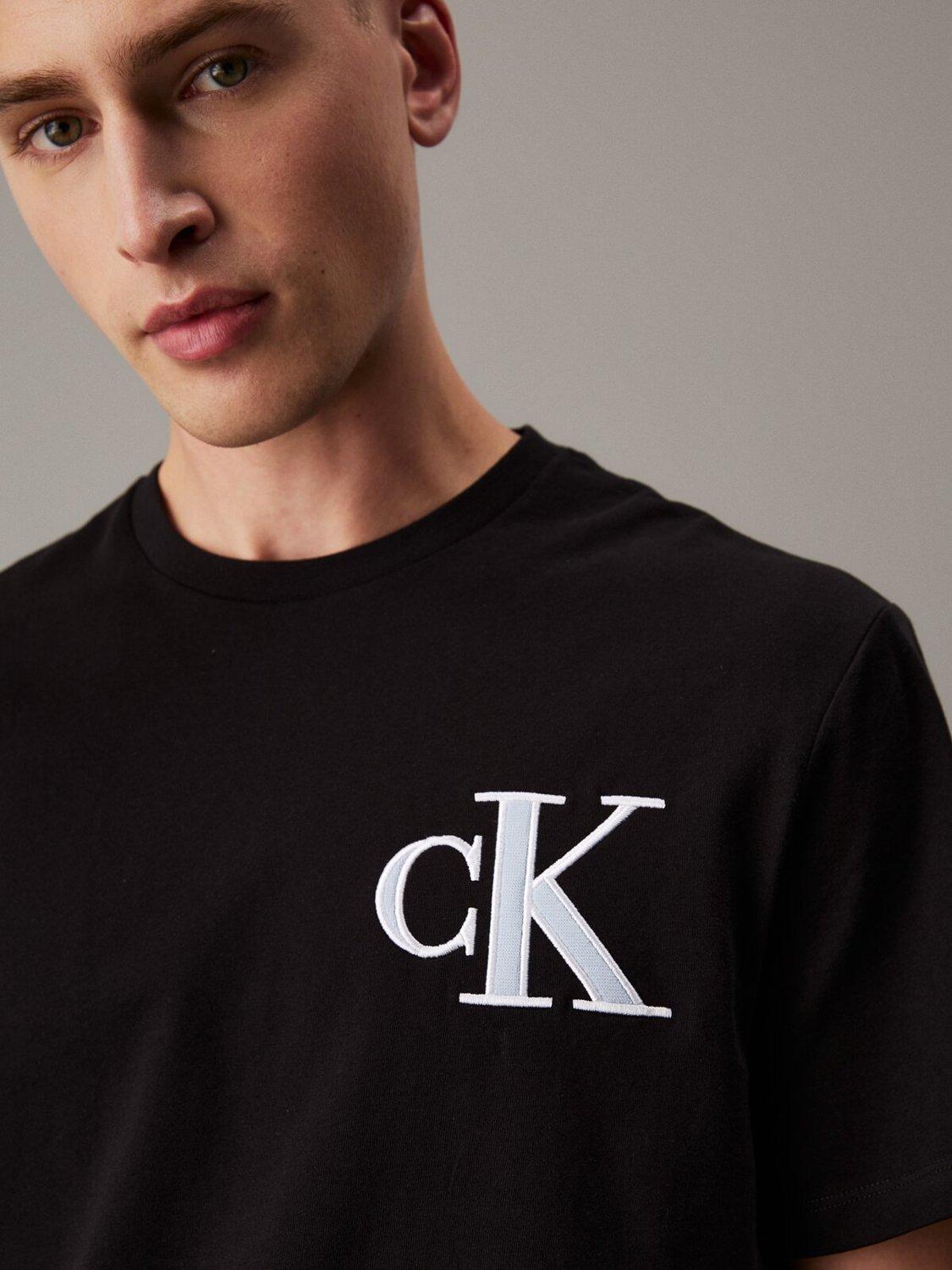 Product image 3 of 4, which shows Calvin Klein Cotton Relaxed Fit Short Sleeve Varsity T-Shirt, Black, XS