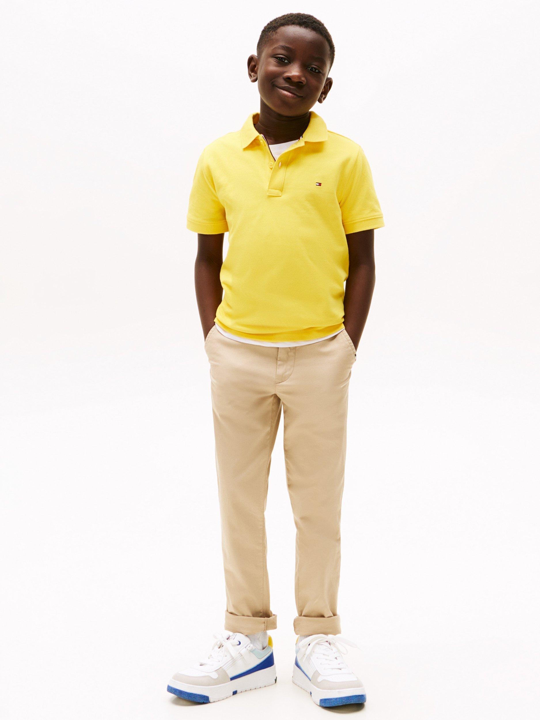 Product image 1 of 5, which shows Tommy Hilfiger Kids' Flag Short Sleeve Polo Shirt, Star Fruit Yellow, 16 years