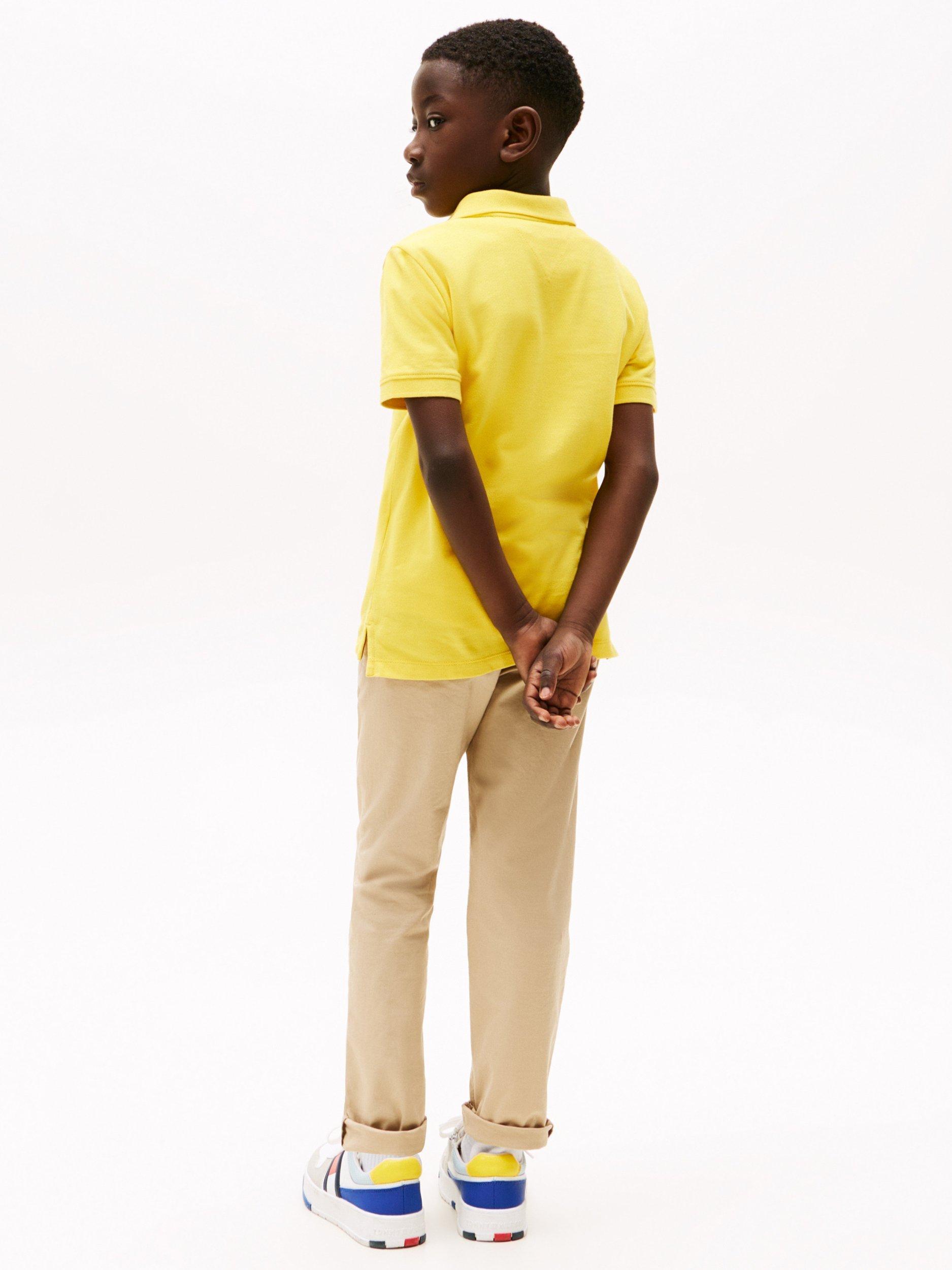 Product image 2 of 5, which shows Tommy Hilfiger Kids' Flag Short Sleeve Polo Shirt, Star Fruit Yellow, 16 years