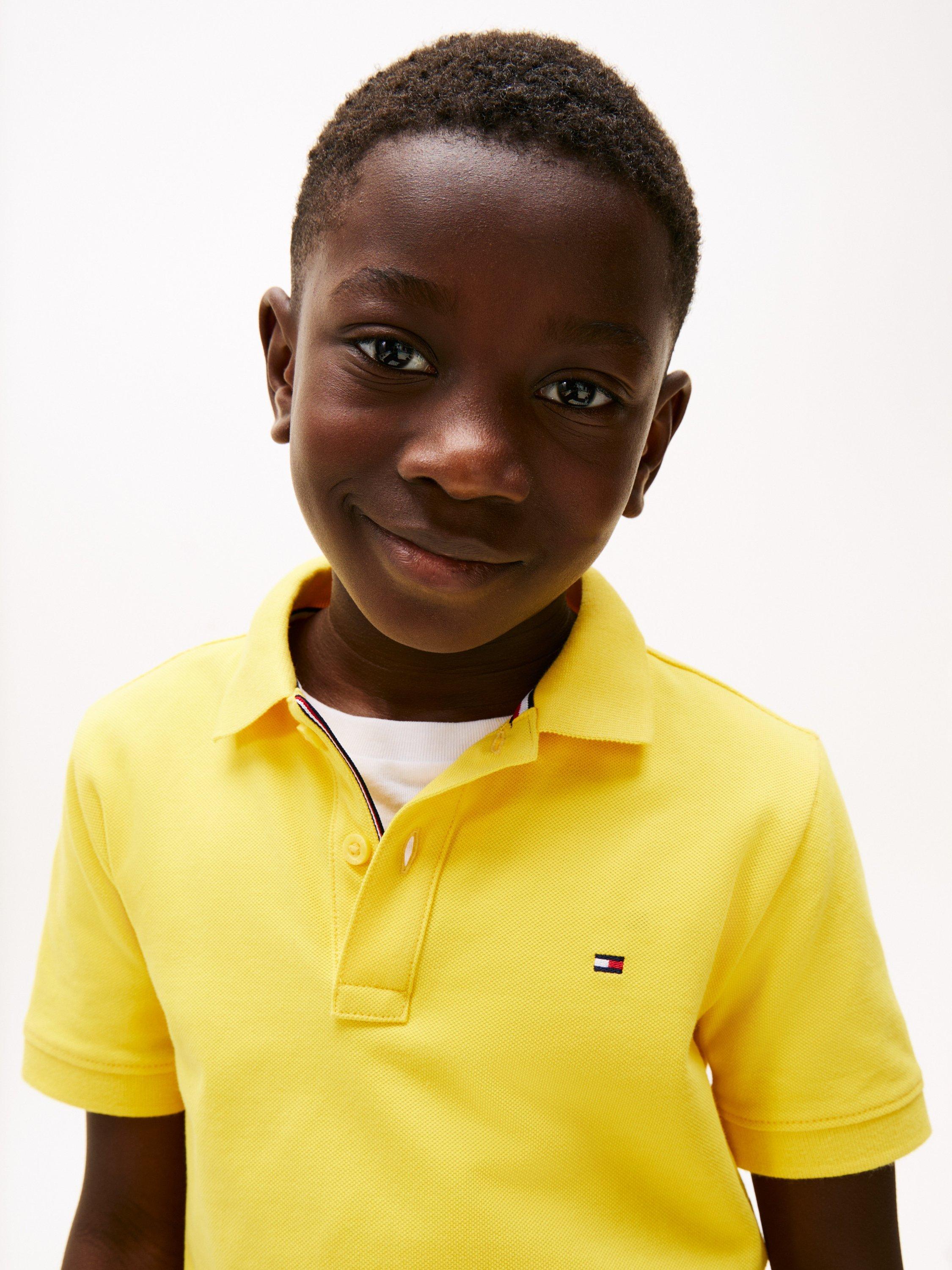 Product image 3 of 5, which shows Tommy Hilfiger Kids' Flag Short Sleeve Polo Shirt, Star Fruit Yellow, 16 years